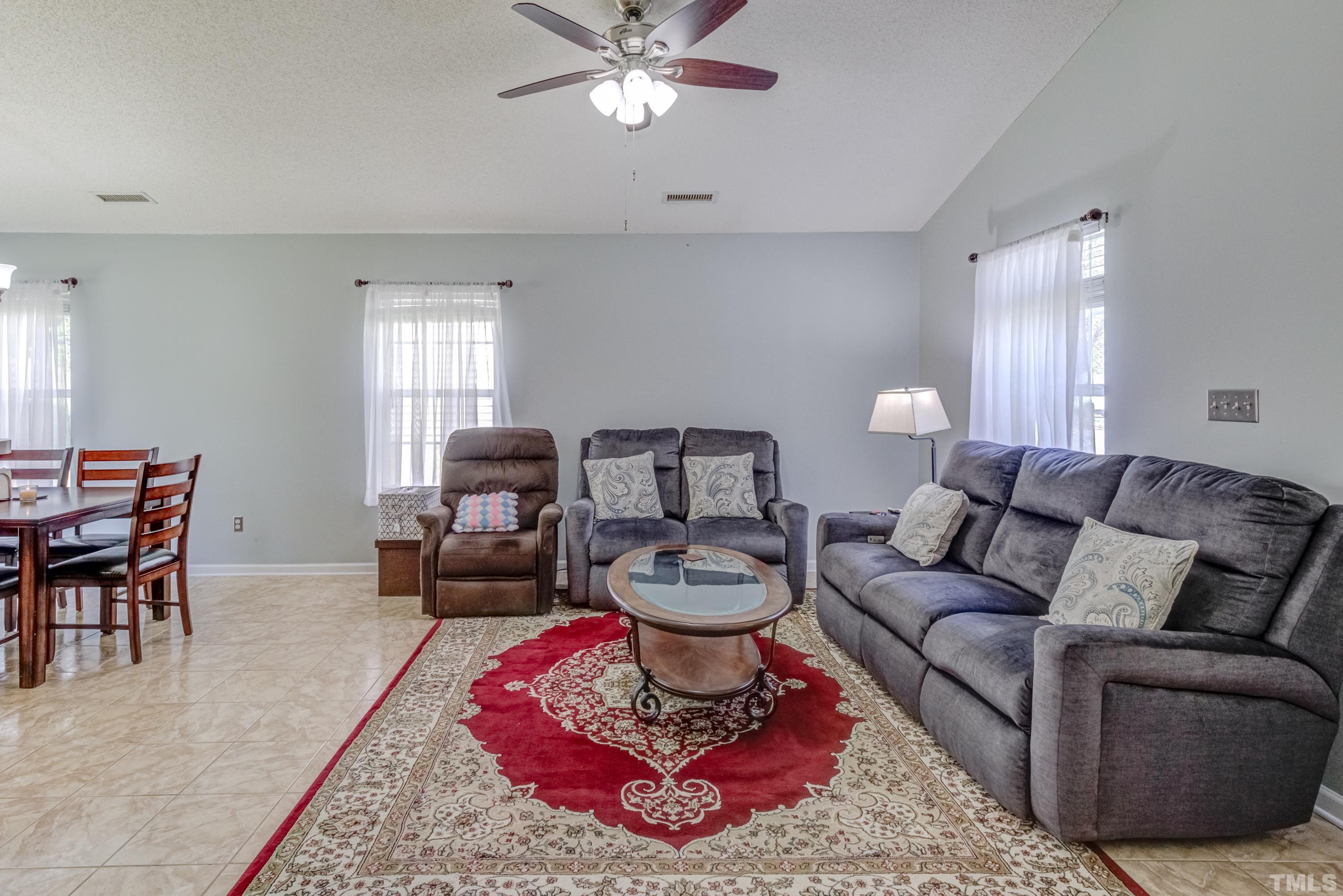 4917 Silverdene Street Raleigh, NC 27616 - Photo 10 of 37 a living room with furniture and a fireplace