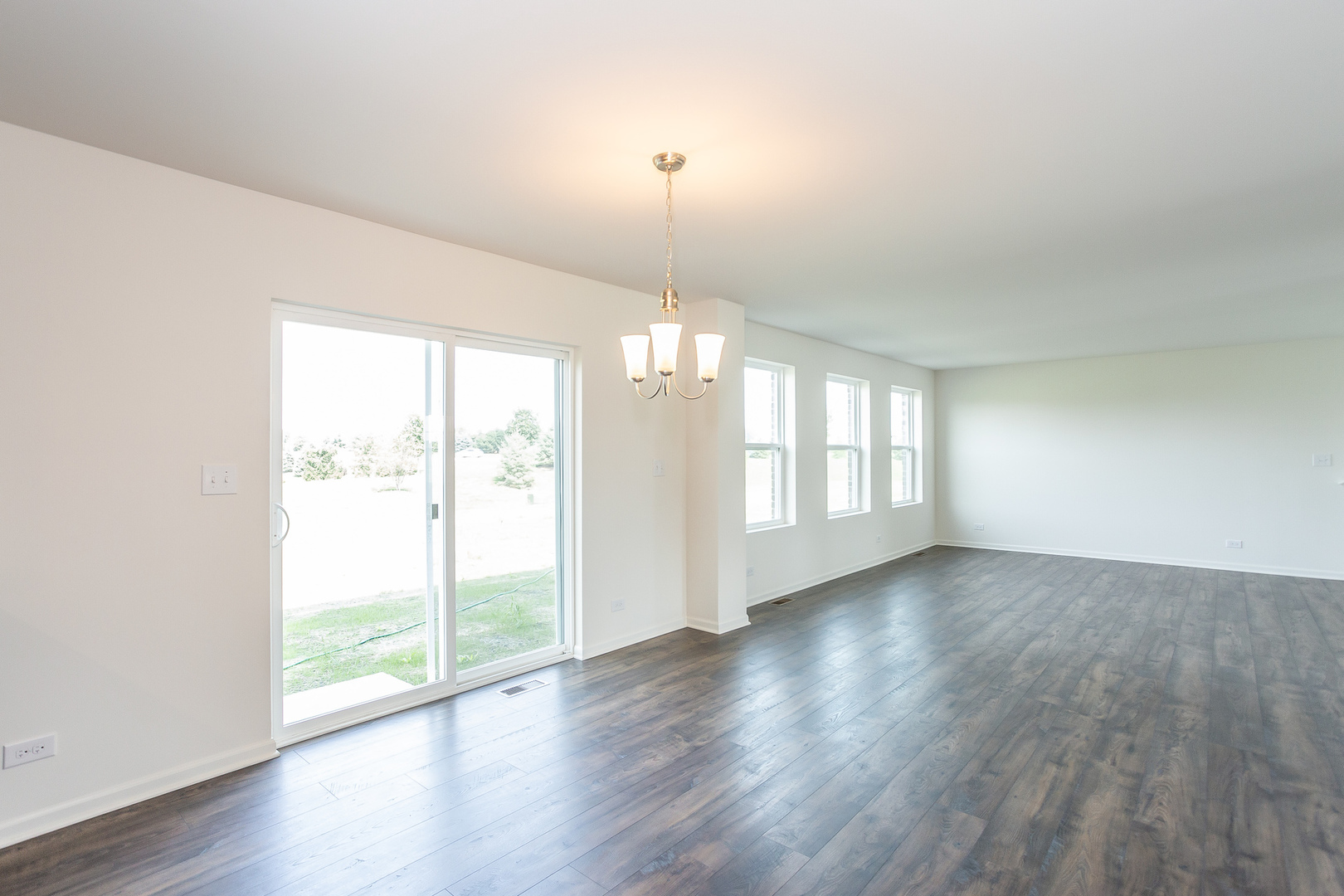 971 Redcliff Road New Lenox, IL 60451 - Photo 5 of 51 a view of an empty room with wooden floor and a window
