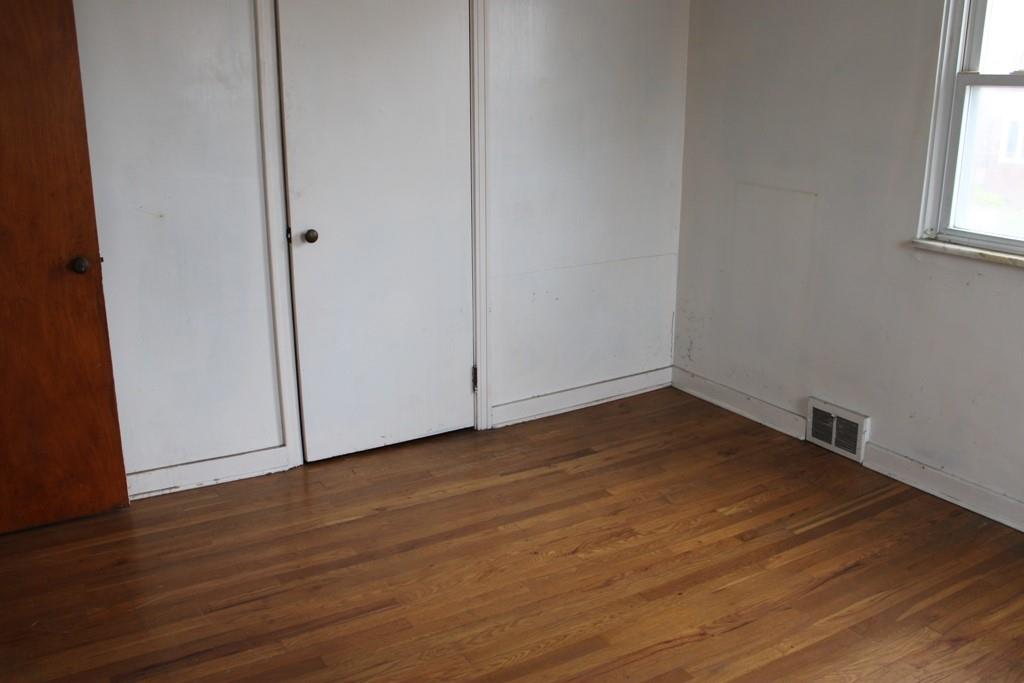 825 Liberty Street Duquesne, PA 15110 - Photo 15 of 25 a view of empty room with wooden floor and fan