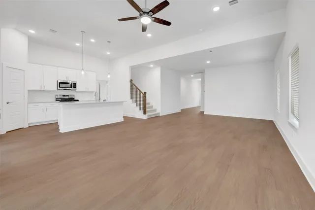 a view of a livingroom with a ceiling fan and window