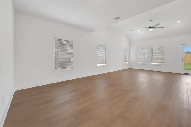 an empty room with windows and closet