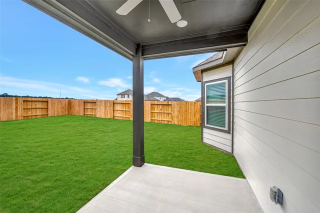 a view of a yard in front of a house with large trees