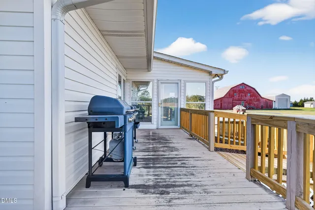 a kitchen with stainless steel appliances kitchen island granite countertop a table chairs and a wooden cabinets