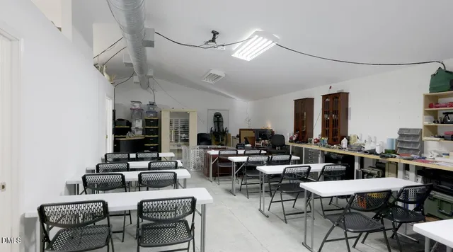 a spacious bathroom with a granite countertop bathtub a sink and a wooden floor