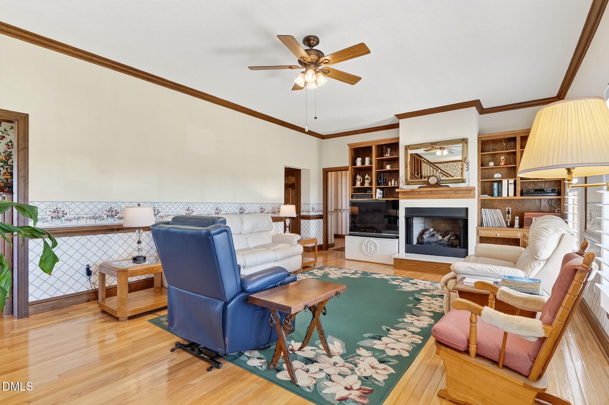 1190 Sanders Road Benson, NC 27504 - Photo 31 of 96 a living room with furniture a fireplace and a flat screen tv