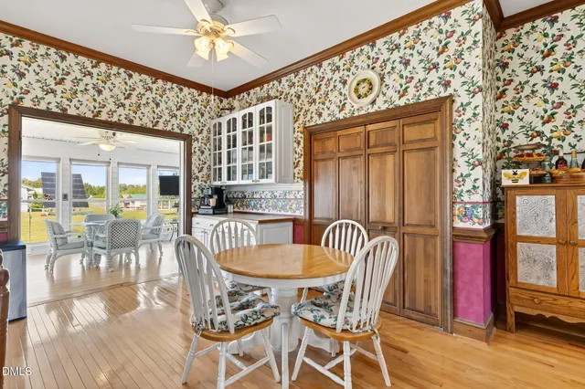 a bedroom with a bed a chair and potted plant on the table