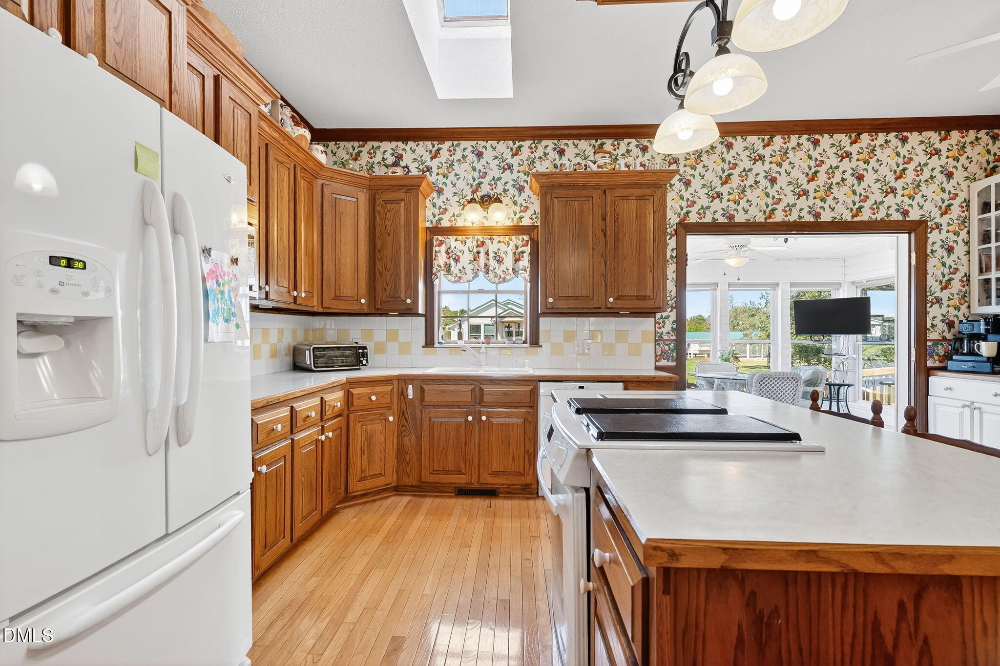 1190 Sanders Road Benson, NC 27504 - Photo 41 of 96 a kitchen with stainless steel appliances granite countertop a sink stove and refrigerator