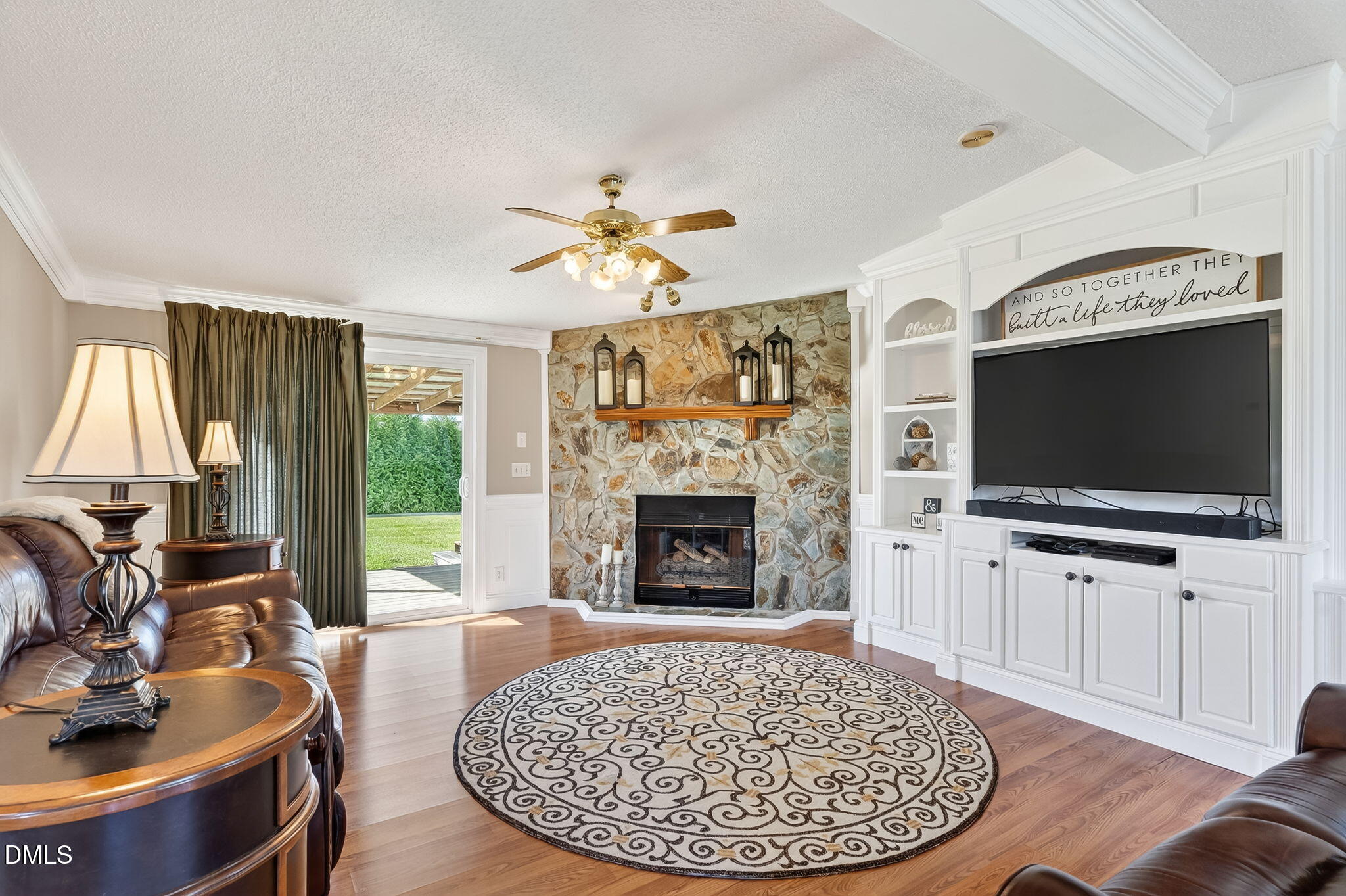 1190 Sanders Road Benson, NC 27504 - Photo 60 of 96 a living room with furniture a flat screen tv and a fireplace