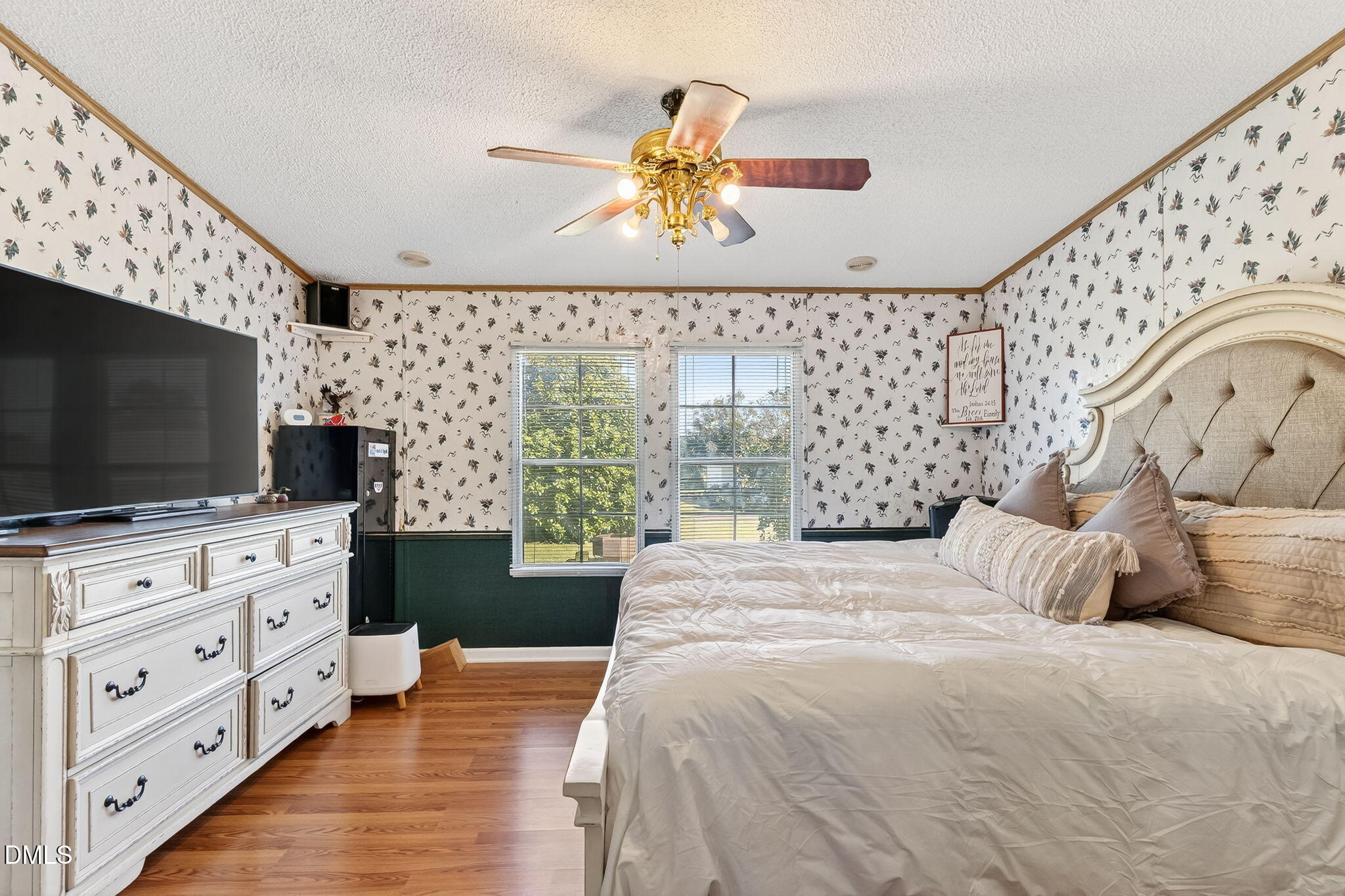 1190 Sanders Road Benson, NC 27504 - Photo 69 of 96 a bedroom with a bed and flat screen tv