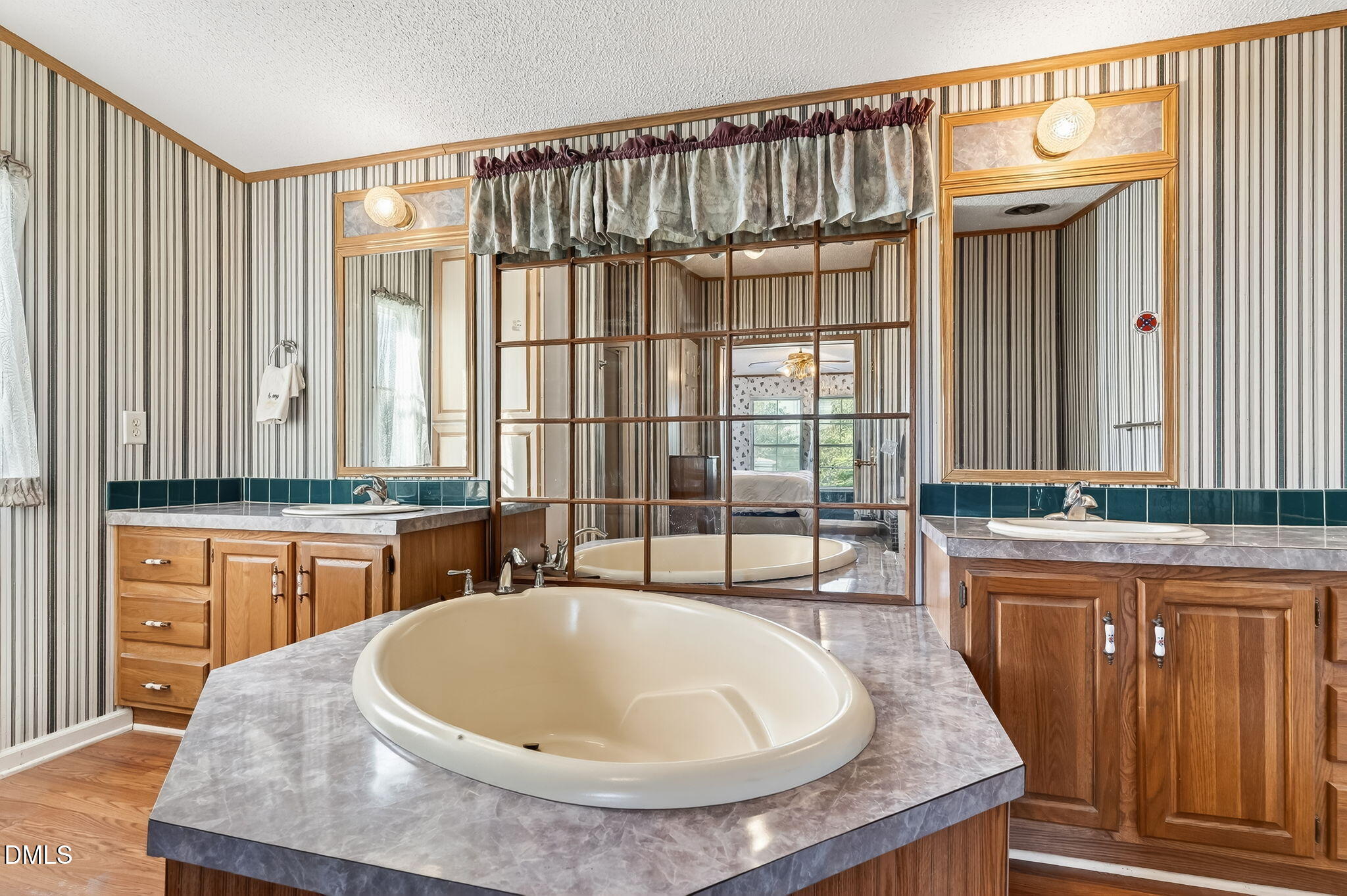1190 Sanders Road Benson, NC 27504 - Photo 70 of 96 a large kitchen with granite countertop a sink and a wooden floor