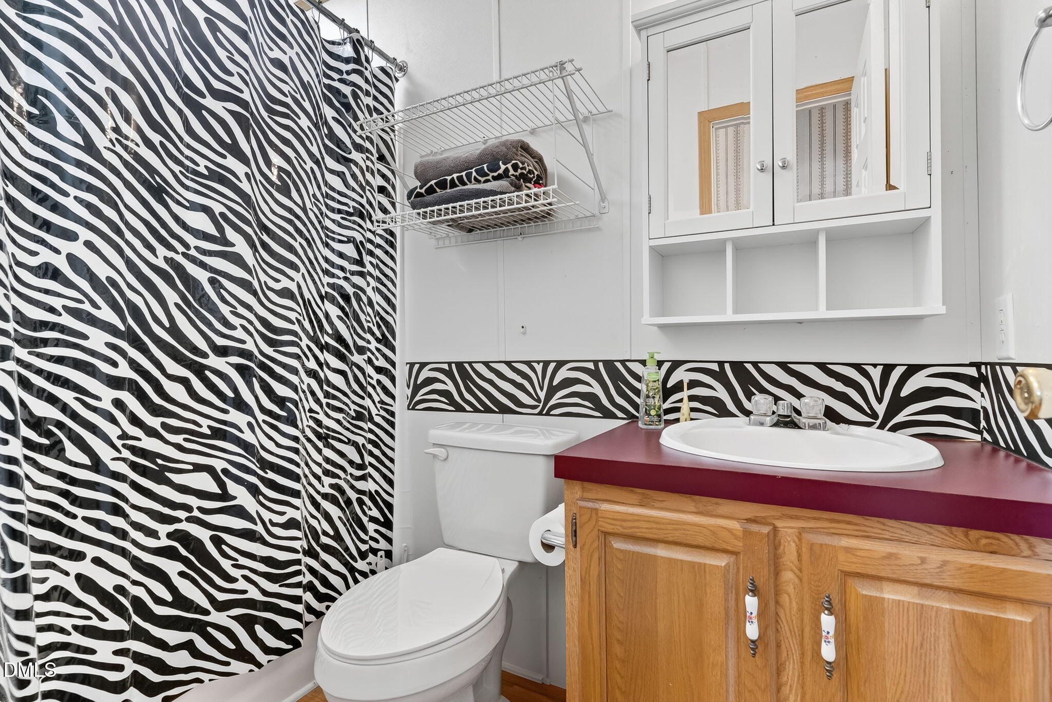 1190 Sanders Road Benson, NC 27504 - Photo 73 of 96 a bathroom with a sink a toilet and mirror