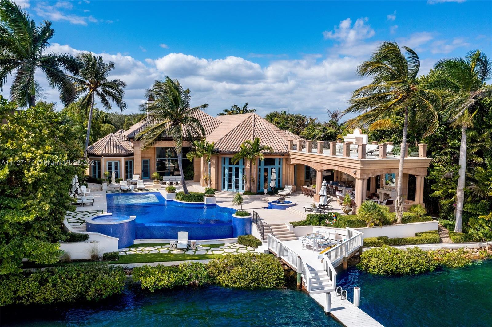 372 Regatta Drive Jupiter, FL 33477 - Photo 2 of 93 a front view of a house with swimming pool and a yard