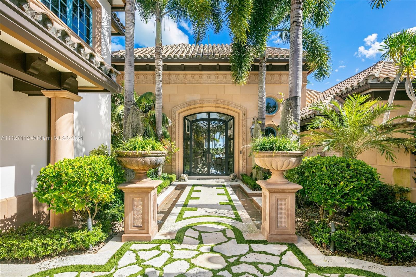 372 Regatta Drive Jupiter, FL 33477 - Photo 19 of 93 a view of a large building with a fountain in front of a house