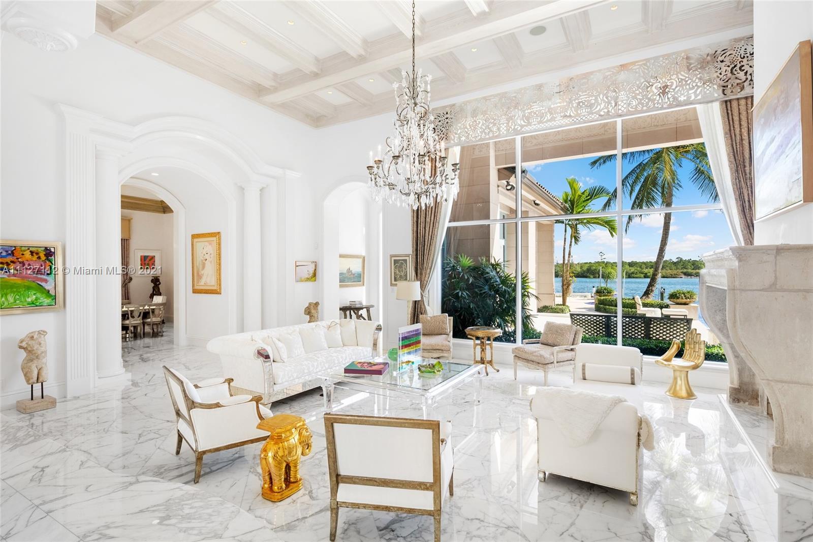 372 Regatta Drive Jupiter, FL 33477 - Photo 24 of 93 a living room with furniture a large window and a chandelier