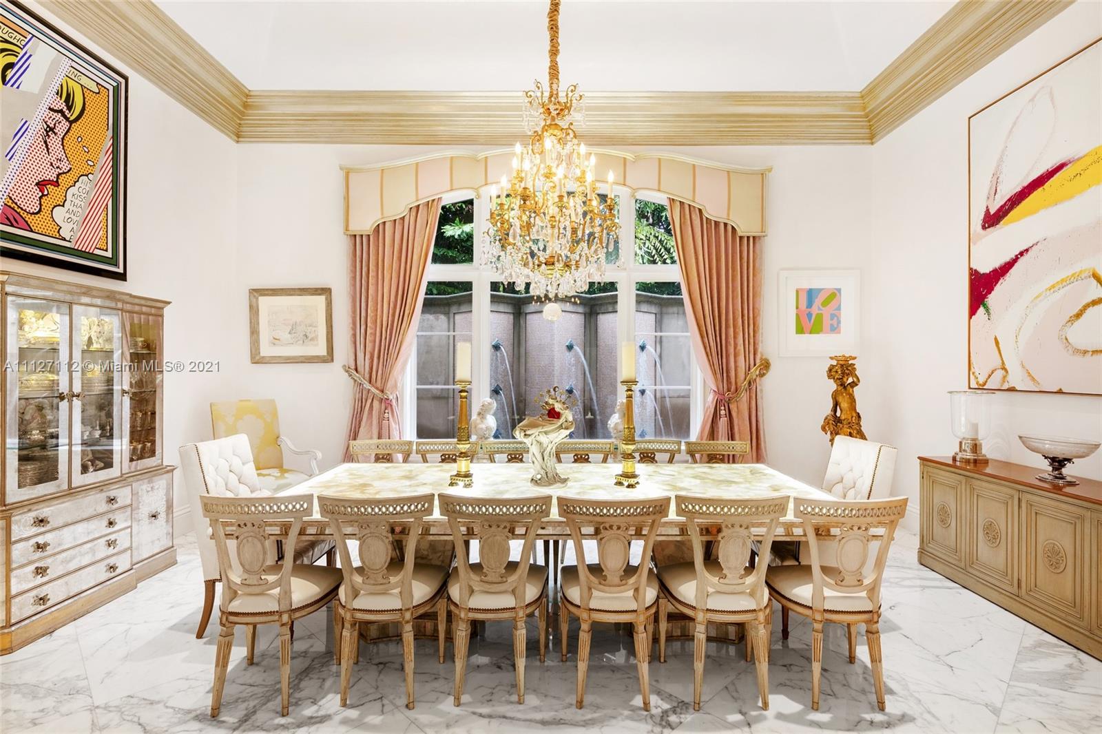 372 Regatta Drive Jupiter, FL 33477 - Photo 36 of 93 a dining room with furniture a chandelier and wooden floor