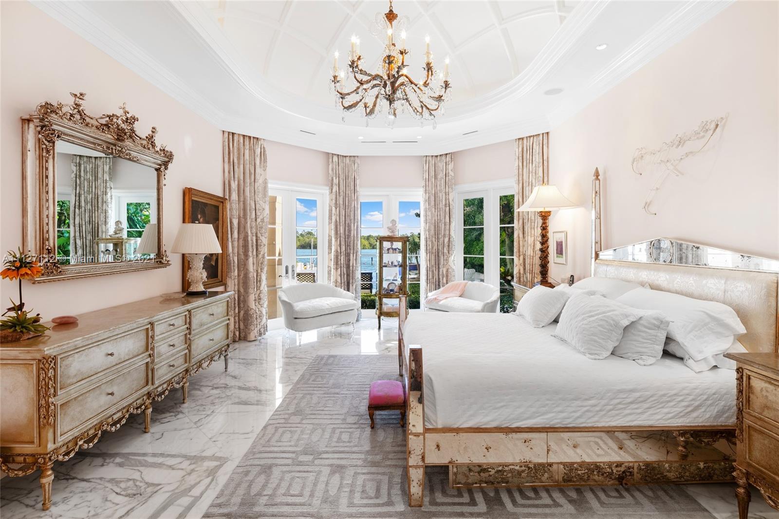 372 Regatta Drive Jupiter, FL 33477 - Photo 40 of 93 a bedroom with a large bed and a chandelier