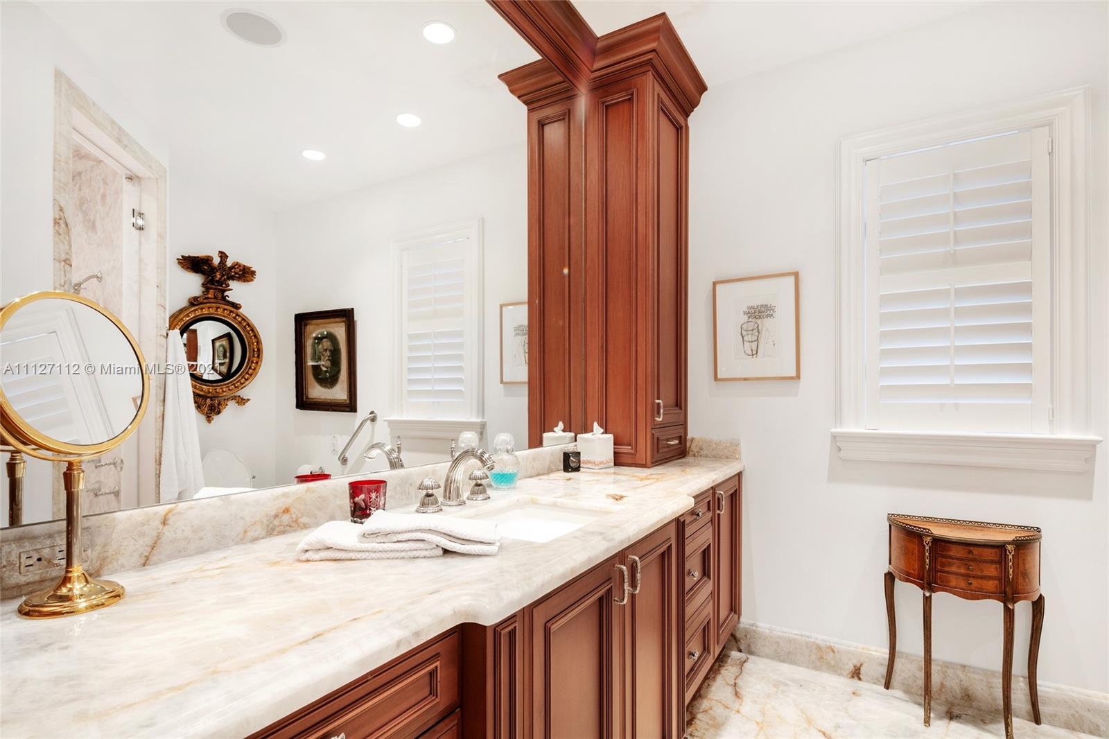 372 Regatta Drive Jupiter, FL 33477 - Photo 45 of 93 a bathroom with a sink and a mirror
