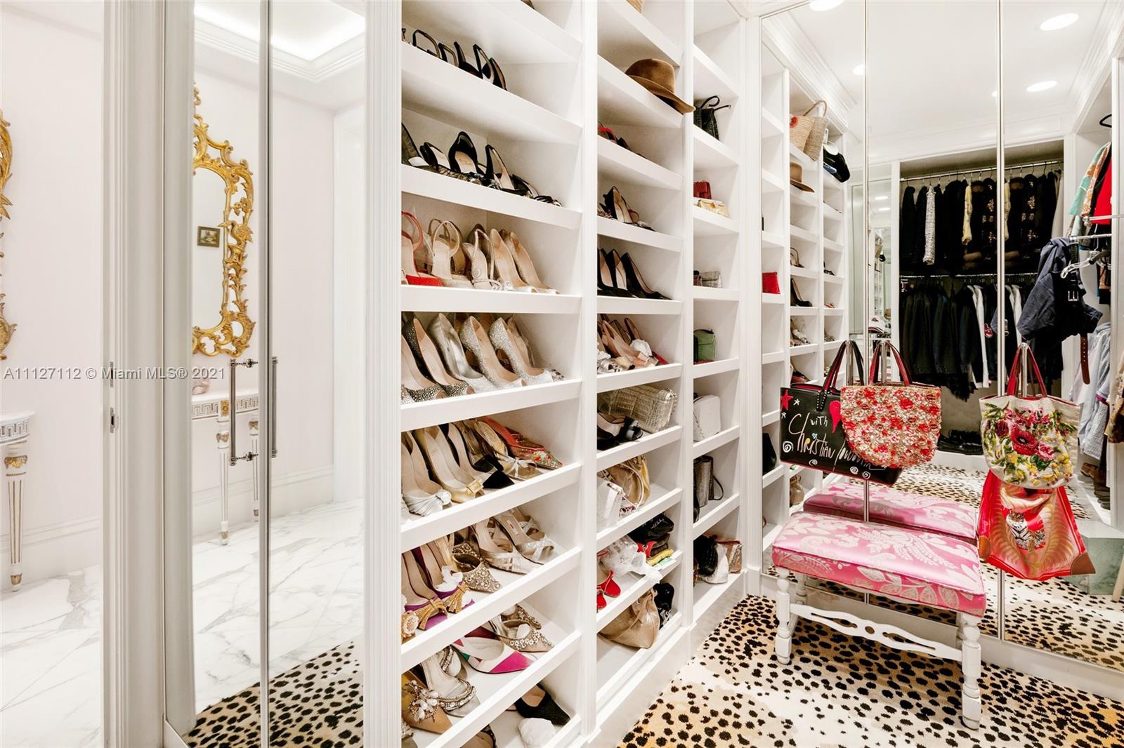 372 Regatta Drive Jupiter, FL 33477 - Photo 49 of 93 a living room with lots of furniture and a book shelf