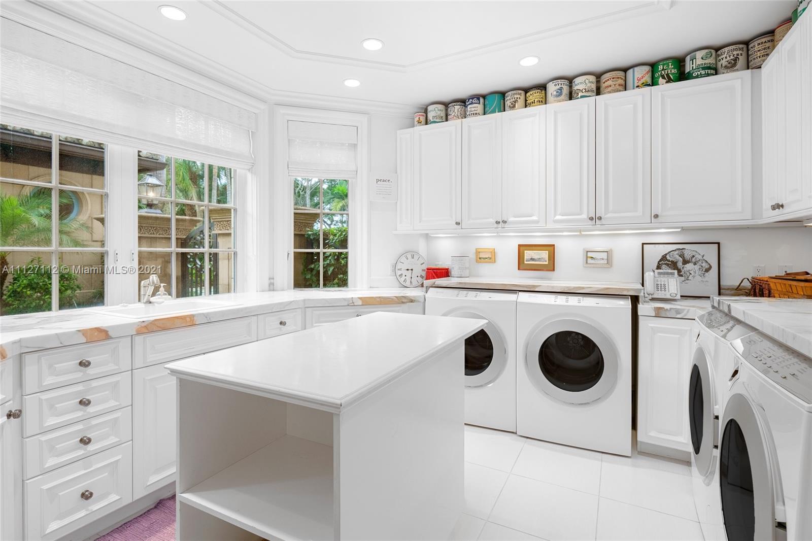 372 Regatta Drive Jupiter, FL 33477 - Photo 59 of 93 a kitchen with a white stove top oven and white cabinets with wooden floor