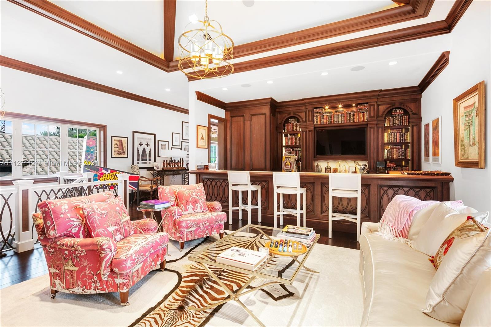 372 Regatta Drive Jupiter, FL 33477 - Photo 60 of 93 a living room with furniture a flat screen tv and a floor to ceiling window