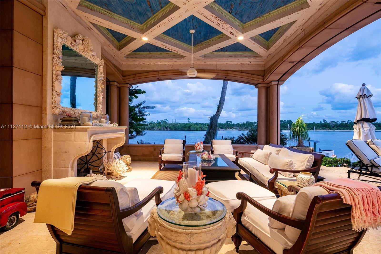 372 Regatta Drive Jupiter, FL 33477 - Photo 83 of 93 a living room with furniture a fireplace and a large window