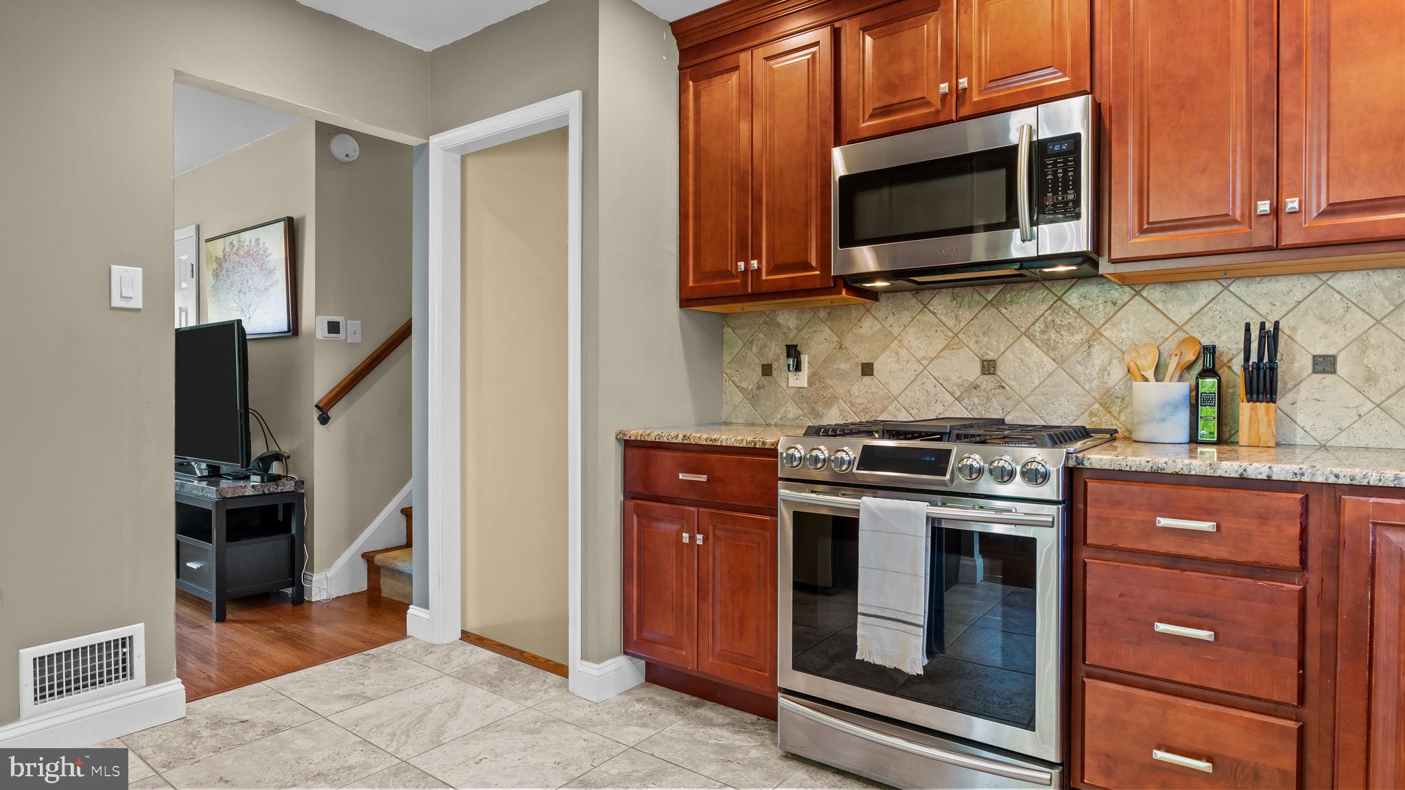 1002 Windsor Road Warminster, PA 18974 - Photo 13 of 57 a kitchen with stainless steel appliances granite countertop a stove microwave and refrigerator