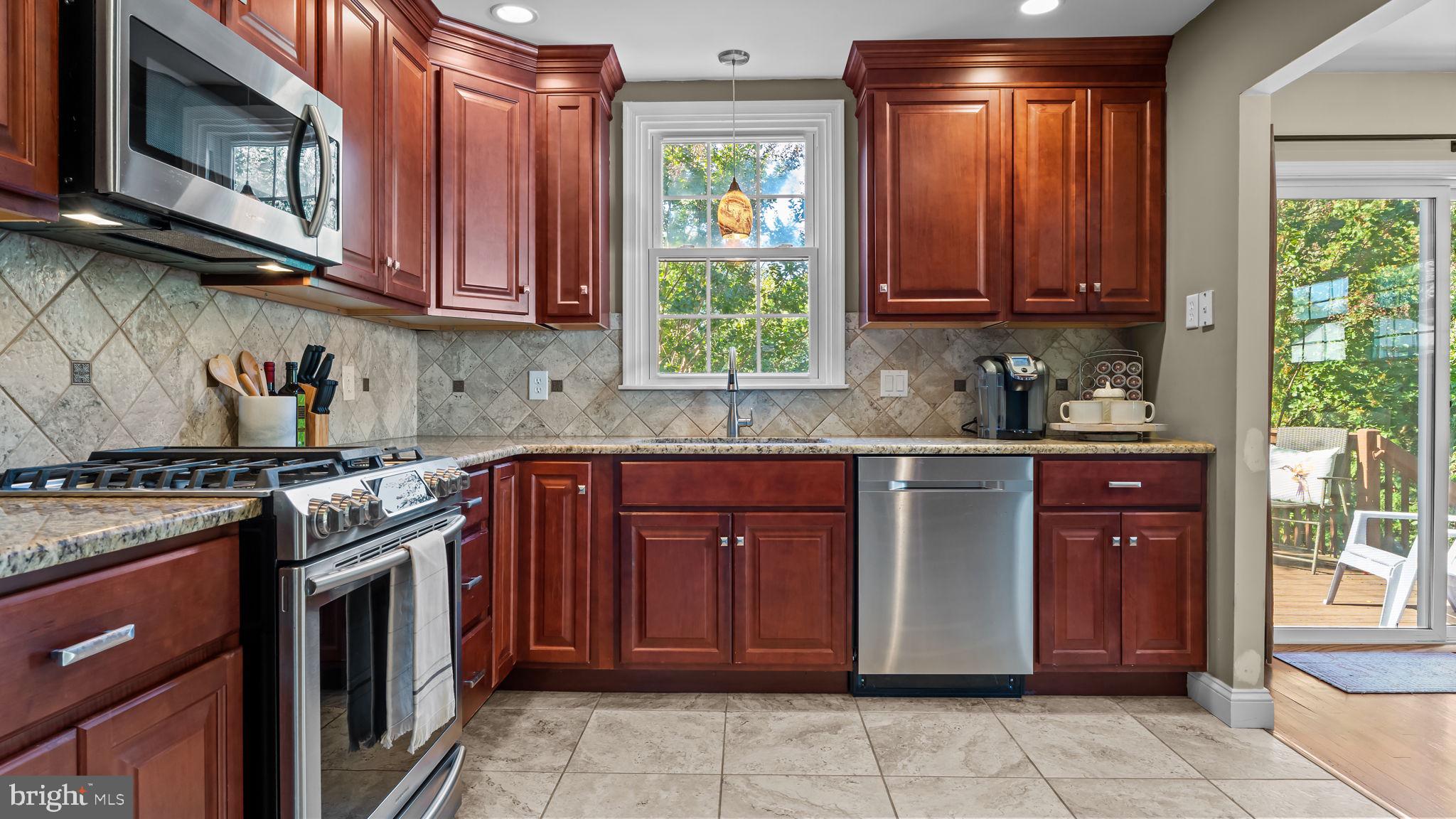 1002 Windsor Road Warminster, PA 18974 - Photo 17 of 57 a kitchen with stainless steel appliances granite countertop a stove sink and cabinets