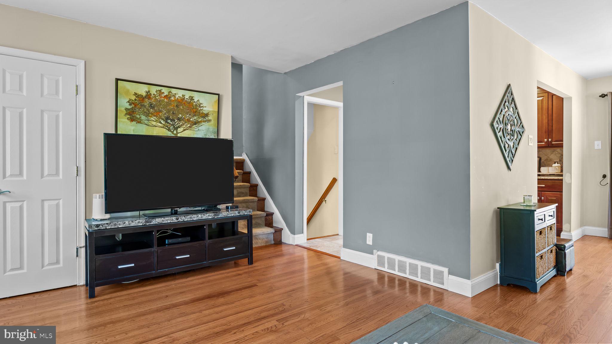 1002 Windsor Road Warminster, PA 18974 - Photo 20 of 57 a living room with wooden floor and flat screen tv