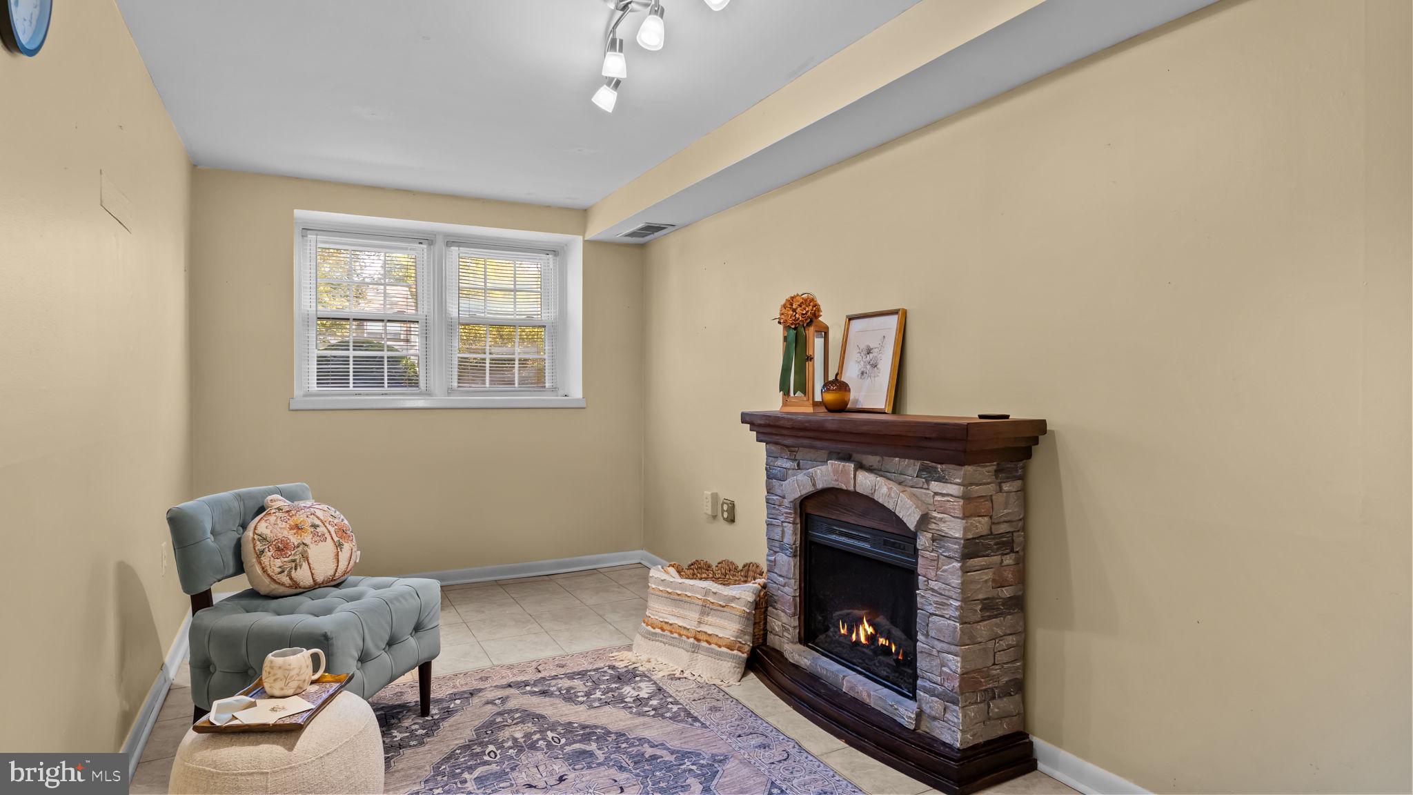 1002 Windsor Road Warminster, PA 18974 - Photo 22 of 57 a living room with furniture and a fireplace
