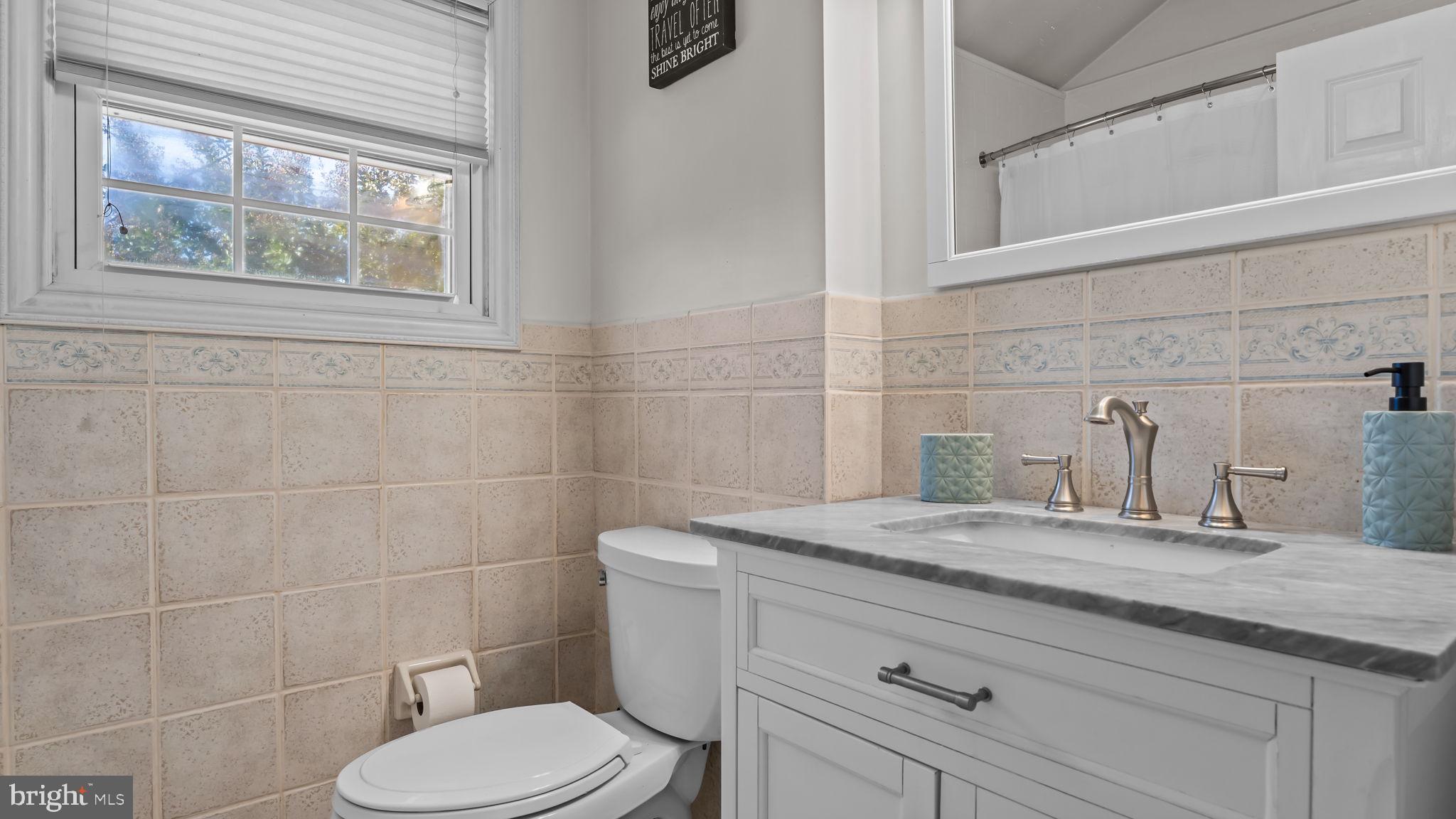 1002 Windsor Road Warminster, PA 18974 - Photo 42 of 57 a bathroom with a granite countertop toilet sink and mirror