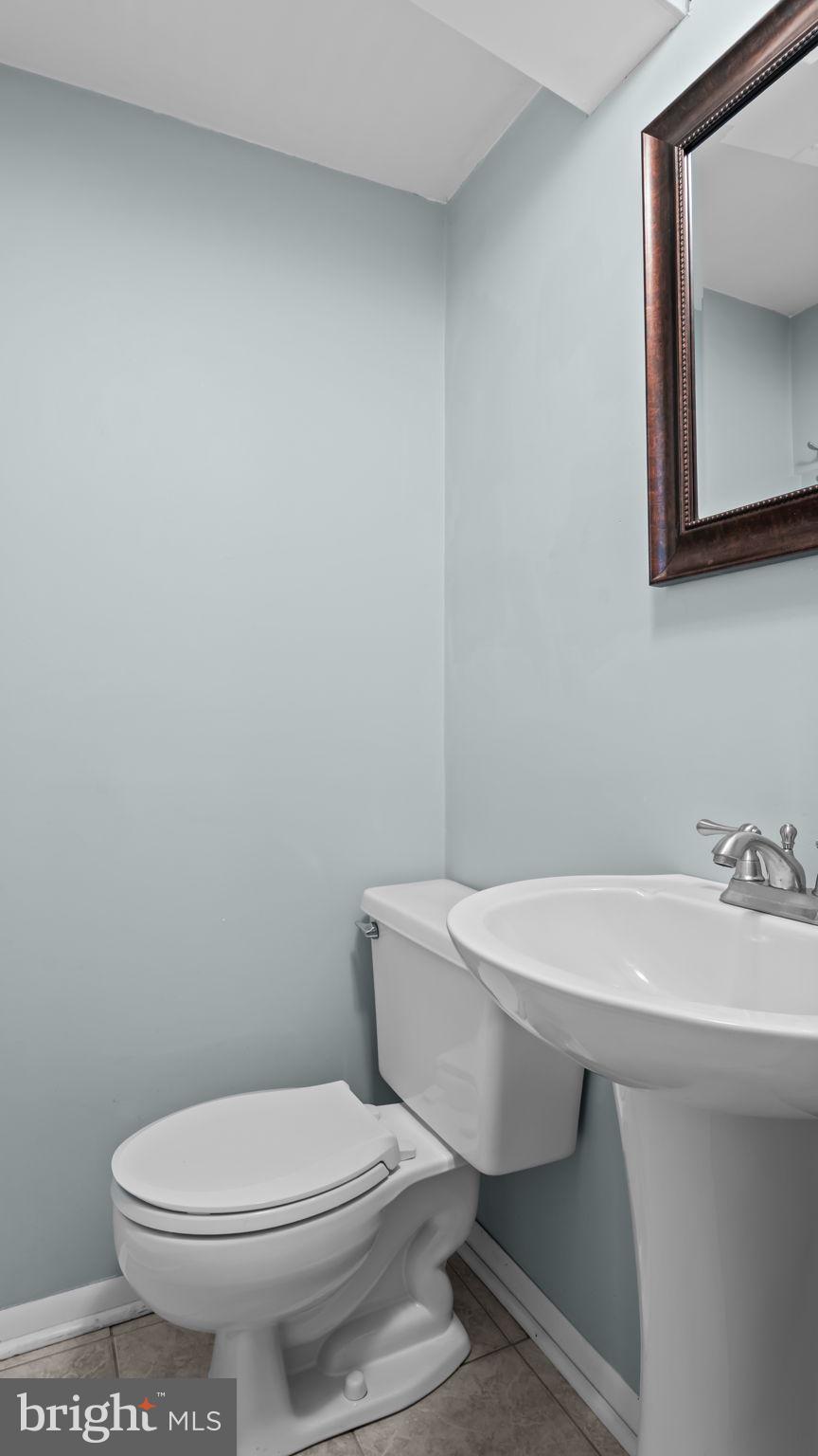 1002 Windsor Road Warminster, PA 18974 - Photo 45 of 57 a bathroom with a sink a toilet and mirror