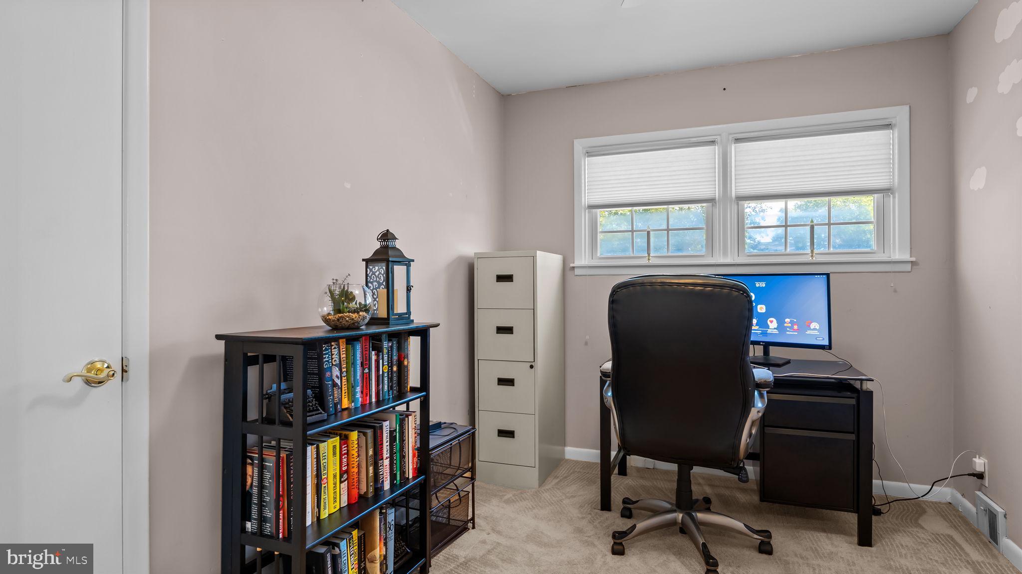 1002 Windsor Road Warminster, PA 18974 - Photo 5 of 57 a view of a workspace with furniture and a bookshelf