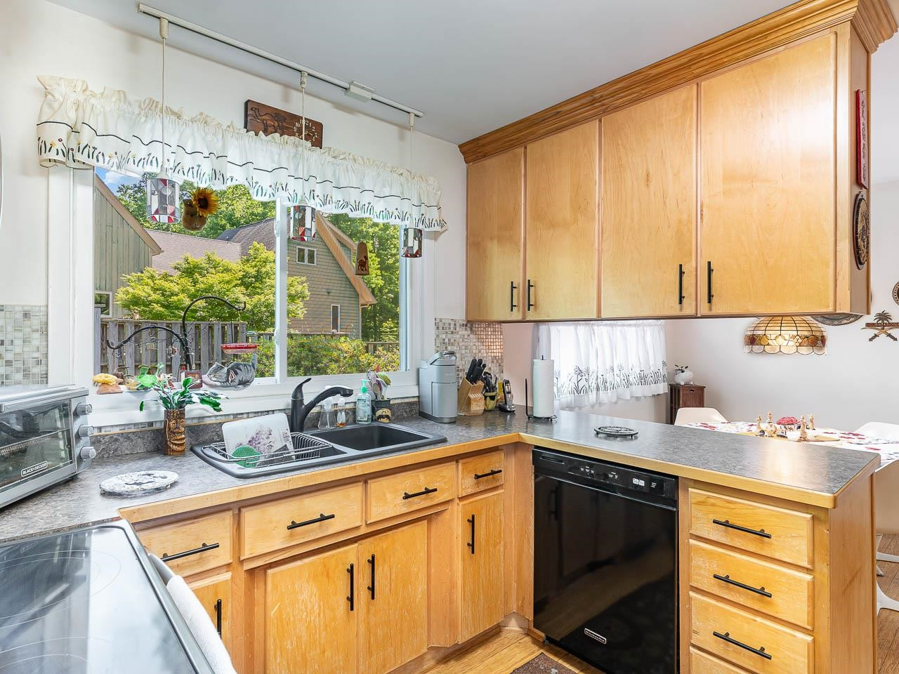 2104 Jarman Drive Raleigh, NC 27604 - Photo 16 of 37 a kitchen with a sink and large window