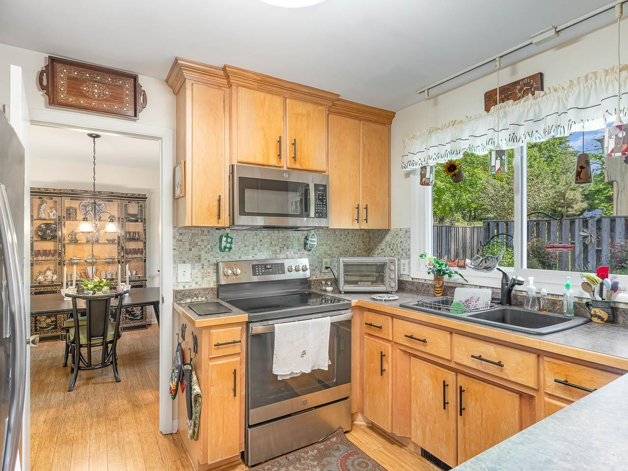 2104 Jarman Drive Raleigh, NC 27604 - Photo 18 of 37 a kitchen with stainless steel appliances granite countertop a stove a sink and a microwave