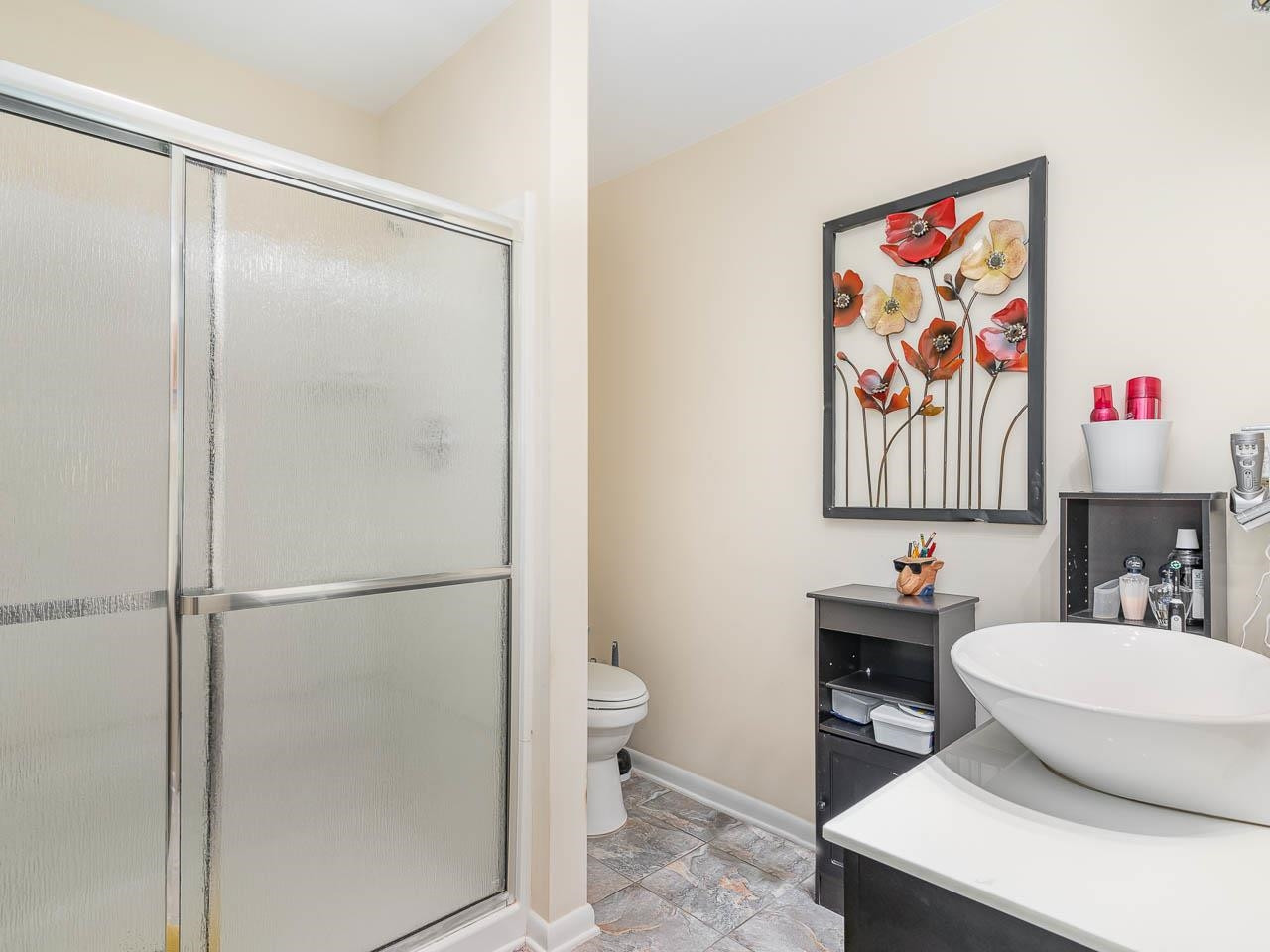 2104 Jarman Drive Raleigh, NC 27604 - Photo 25 of 37 a bathroom with a sink a toilet and shower