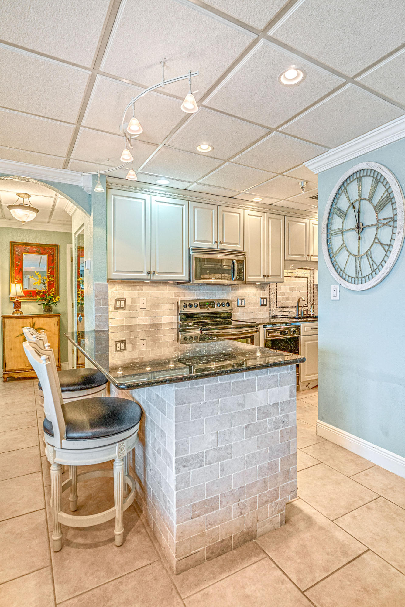 197 Durango Road, Unit 6A Destin, FL 32541 - Photo 11 of 43 a kitchen with stainless steel appliances granite countertop a stove a sink and a refrigerator