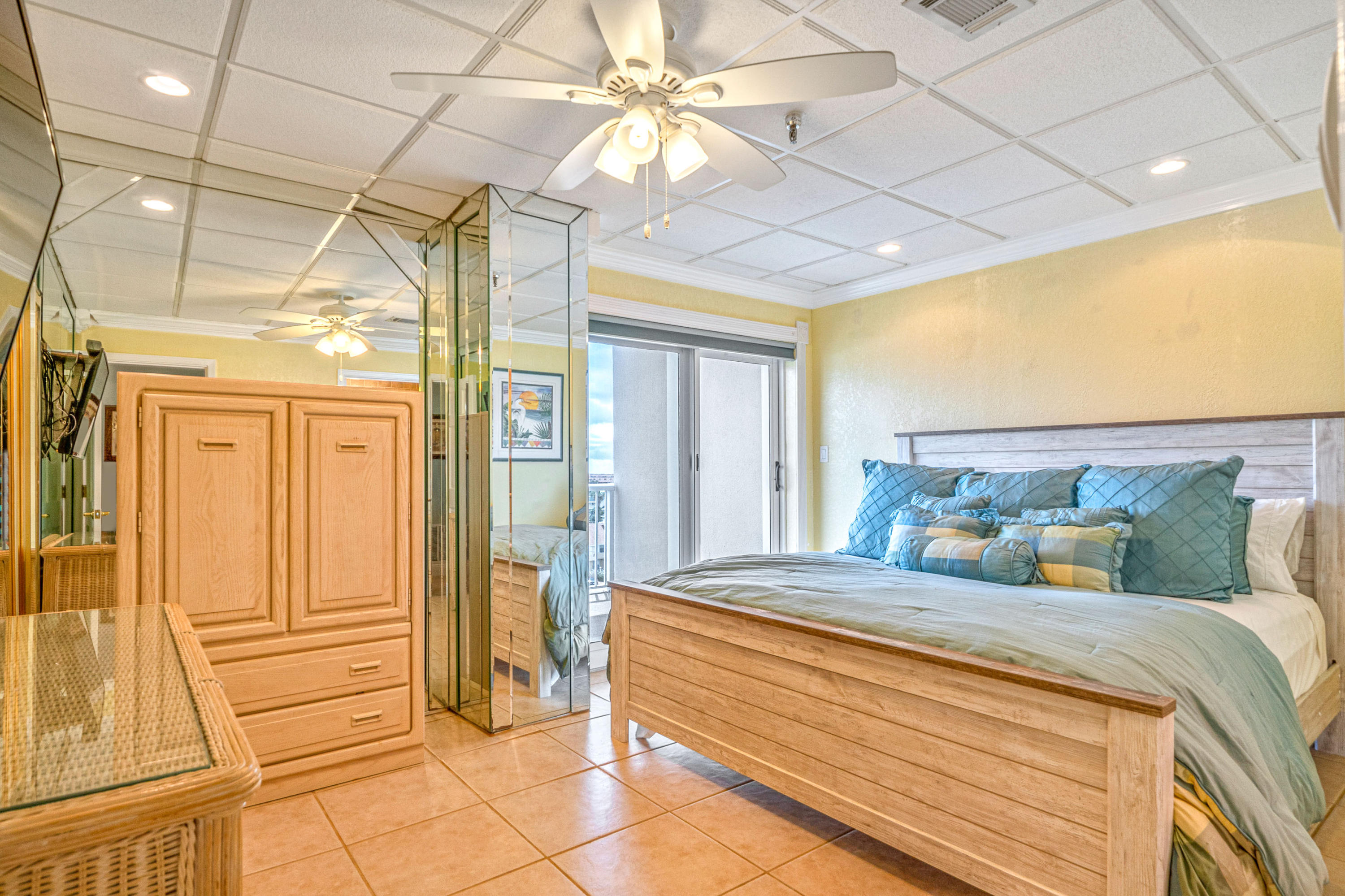 197 Durango Road, Unit 6A Destin, FL 32541 - Photo 15 of 43 a bedroom with a large bed and a chandelier