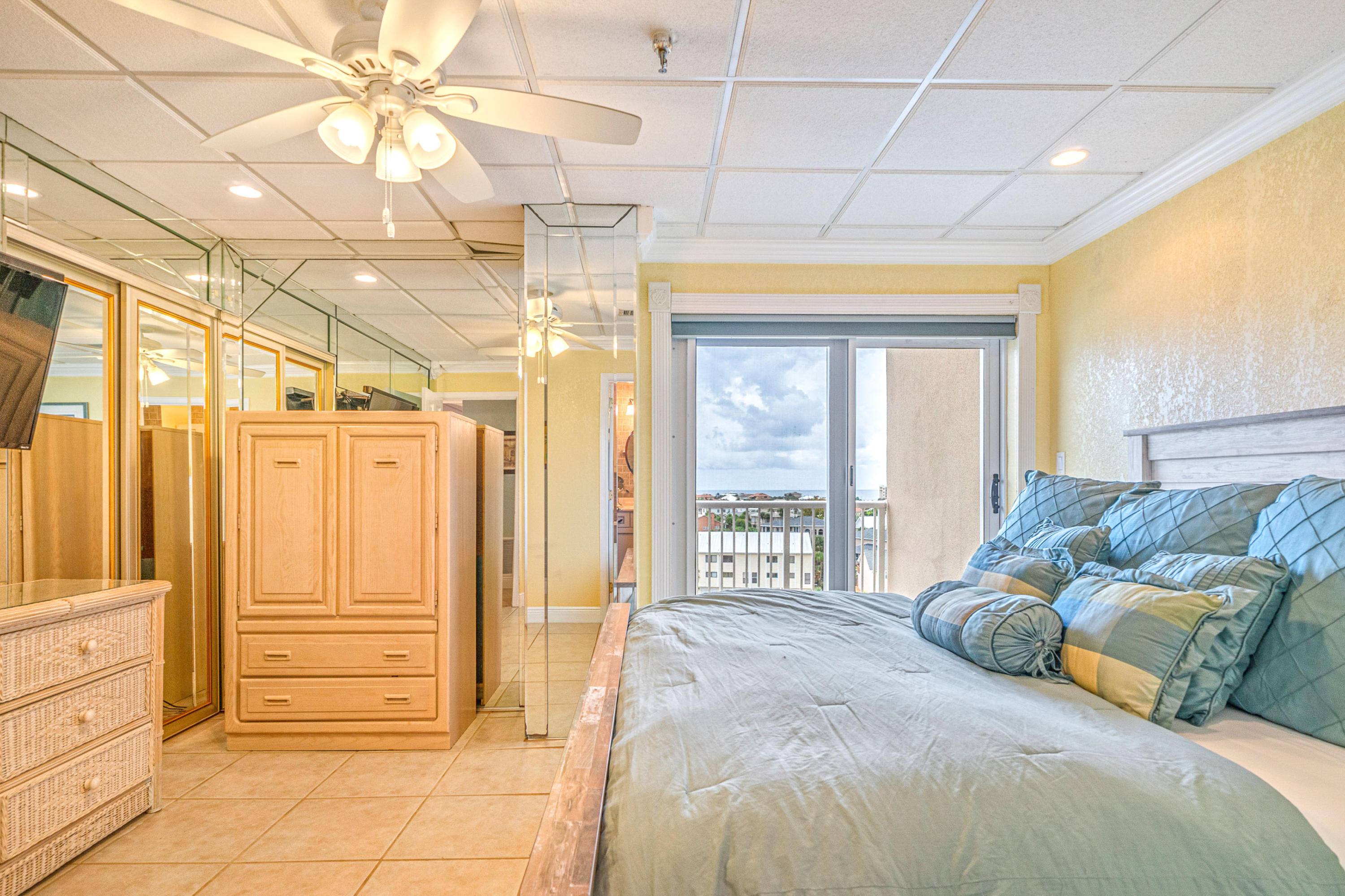 197 Durango Road, Unit 6A Destin, FL 32541 - Photo 17 of 43 a spacious bedroom with a bed and a chandelier