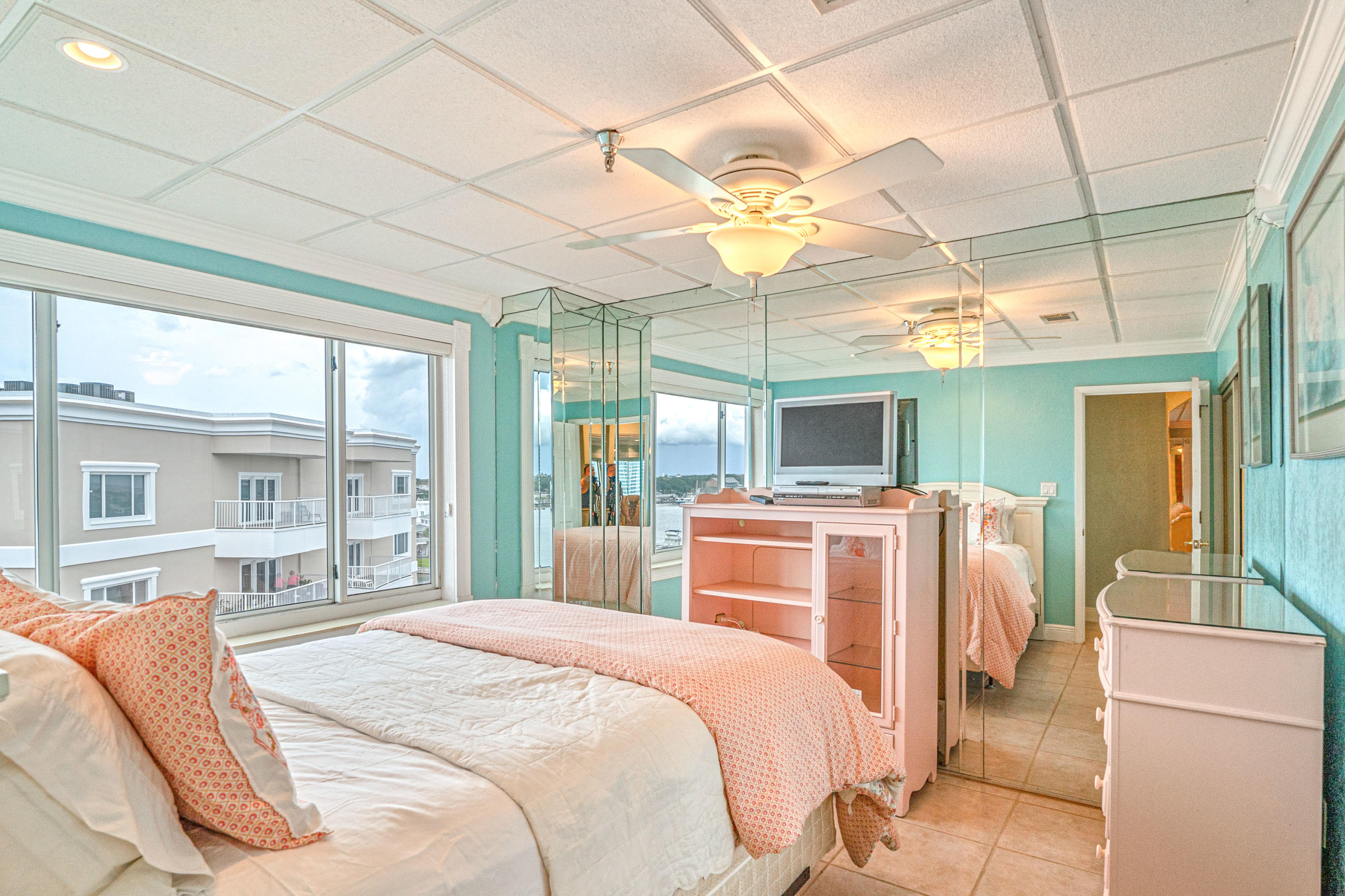 197 Durango Road, Unit 6A Destin, FL 32541 - Photo 23 of 43 a bedroom with bed and a large window