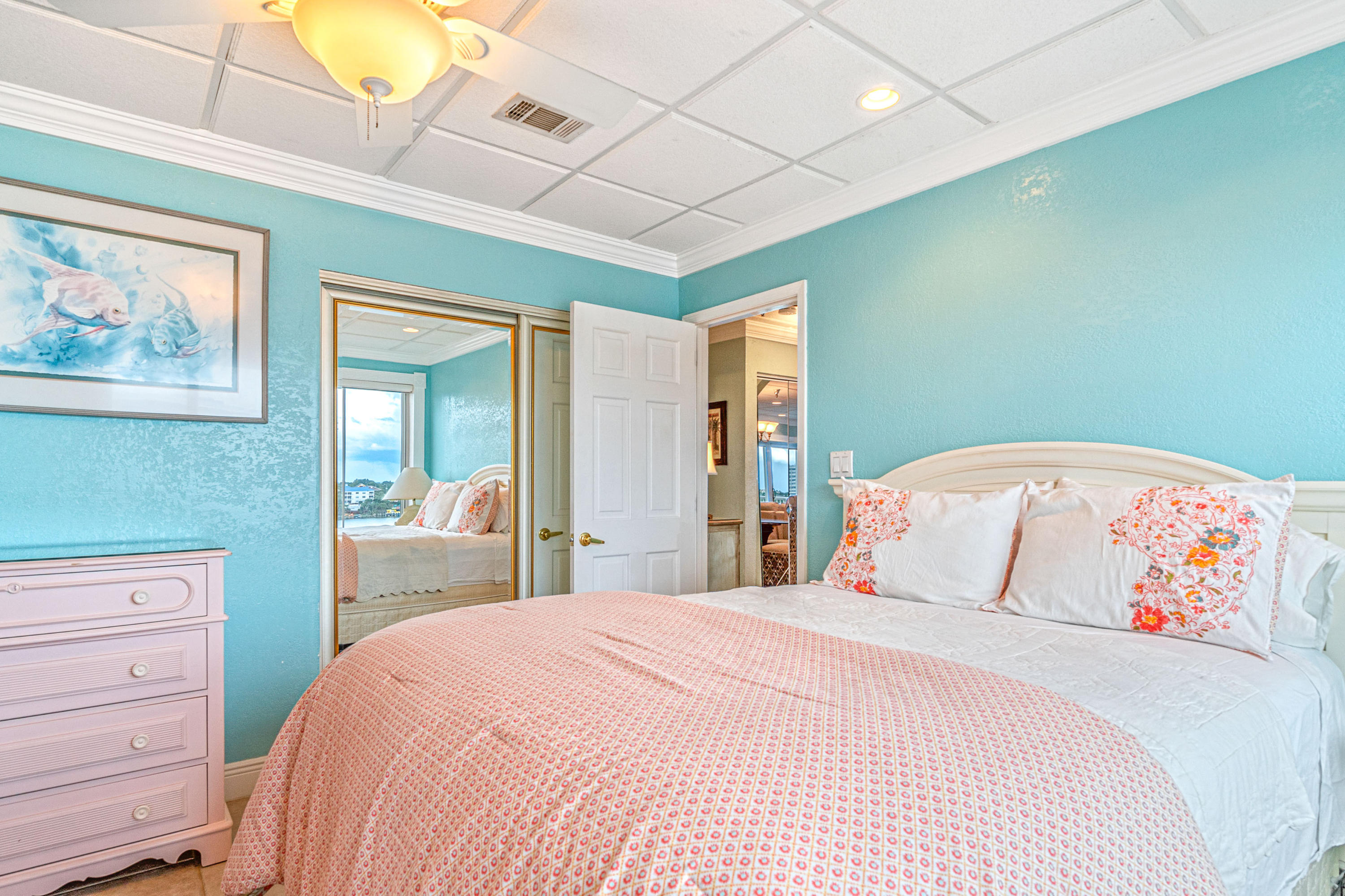 197 Durango Road, Unit 6A Destin, FL 32541 - Photo 24 of 43 a bedroom with a large bed and a chandelier