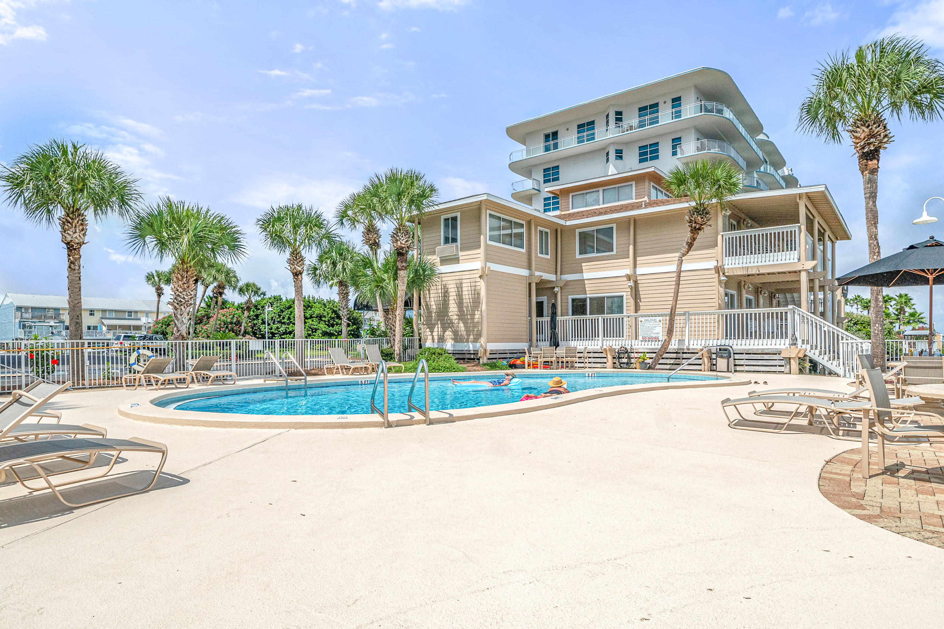 197 Durango Road, Unit 6A Destin, FL 32541 - Photo 28 of 43 a view of a large building with a swimming pool and sitting area