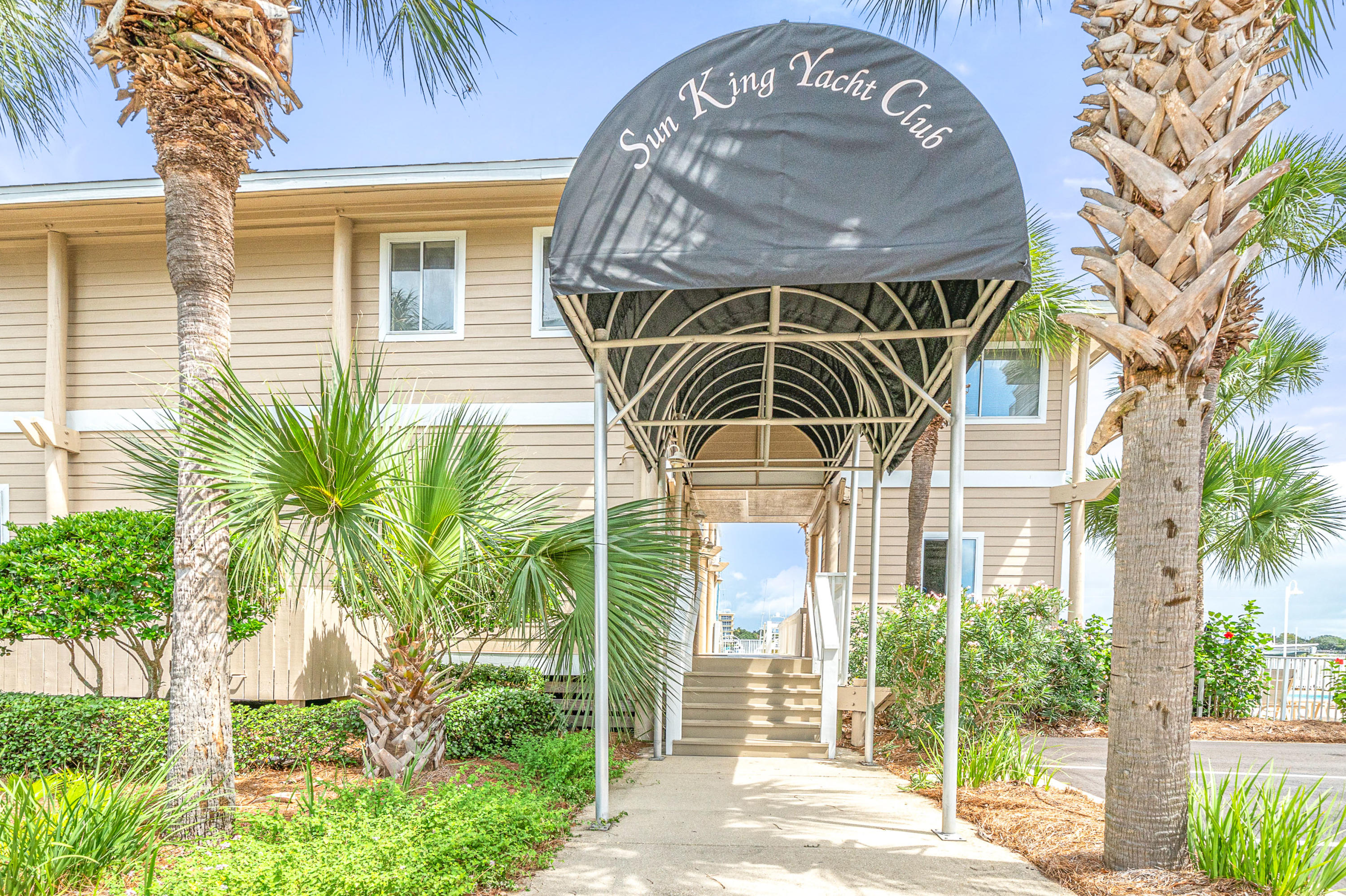 197 Durango Road, Unit 6A Destin, FL 32541 - Photo 39 of 43 a view of a brick house with a large windows and plants