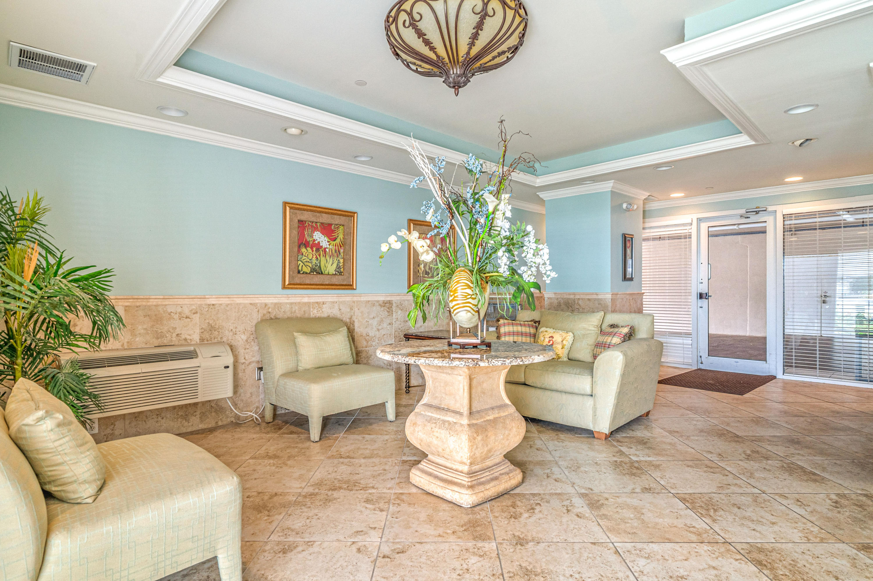 197 Durango Road, Unit 6A Destin, FL 32541 - Photo 42 of 43 a living room with furniture and a chandelier