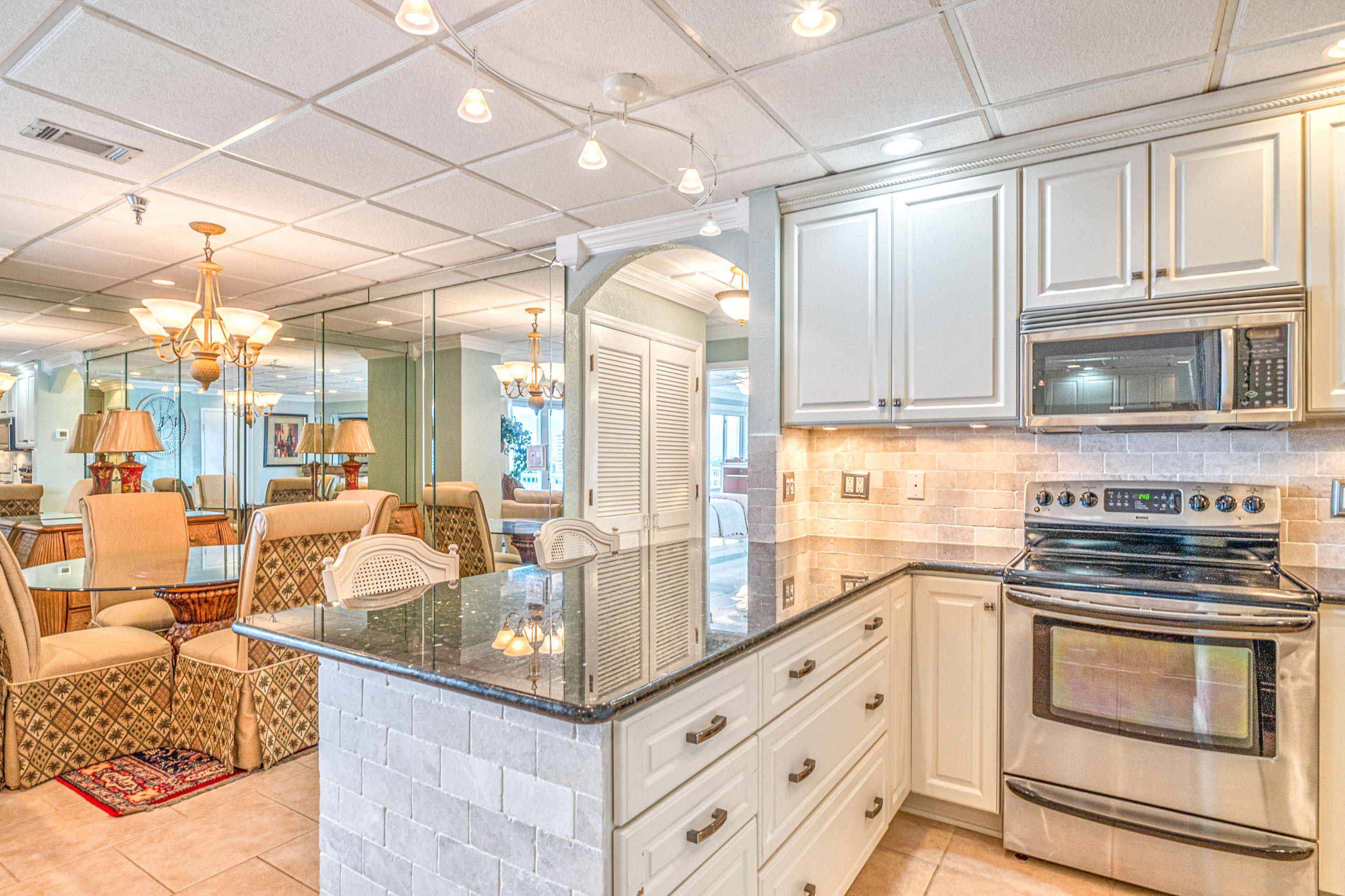 197 Durango Road, Unit 6A Destin, FL 32541 - Photo 10 of 43 a kitchen with stainless steel appliances granite countertop a stove and cabinets