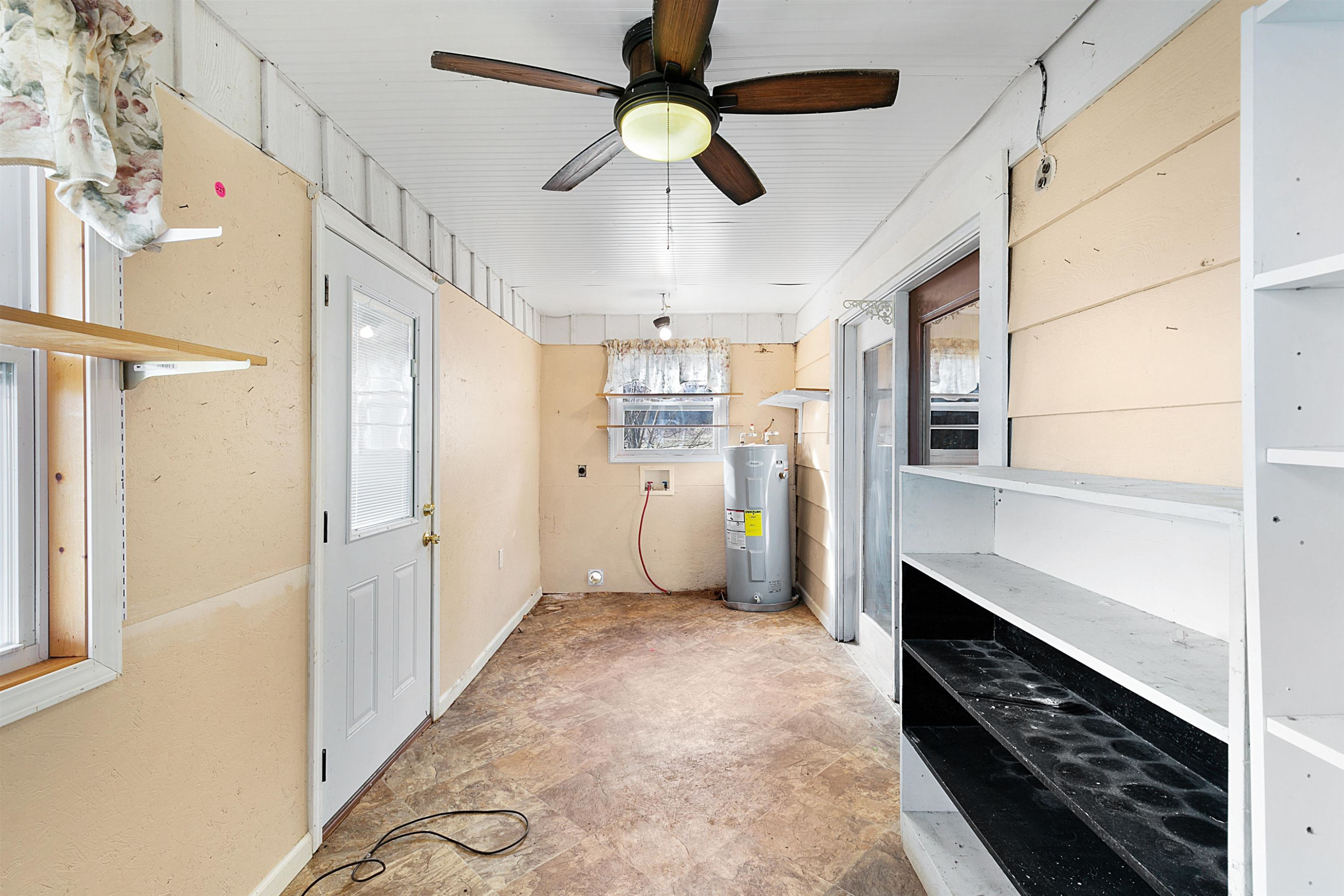 4020 Huron Road Huron, TN 38345 - Photo 12 of 24 a view of a kitchen with refrigerator and a ceiling fan