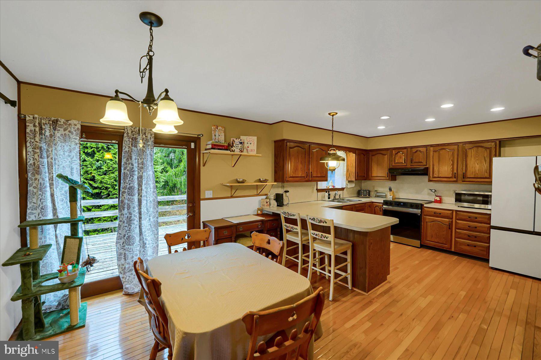 768 Dry Hollow Road Warriors Mark, PA 16877 - Photo 11 of 56 a large kitchen with a table and chairs in it