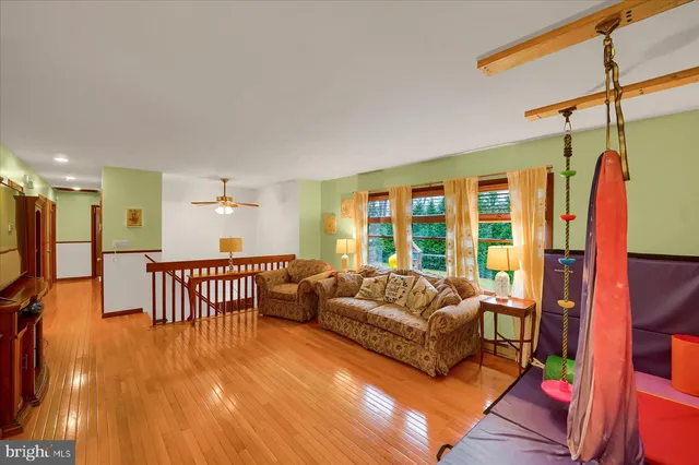 a living room with furniture windows and a flat screen tv