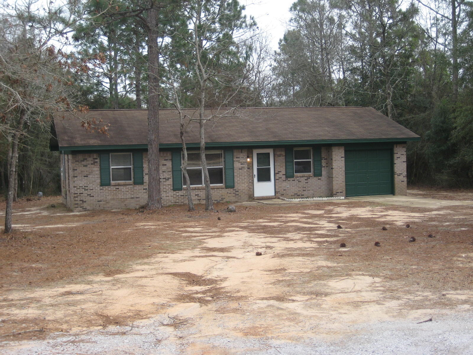 6003 Robin Road Crestview, FL 32539 - Photo 1 of 17 a front view of a house with a garden