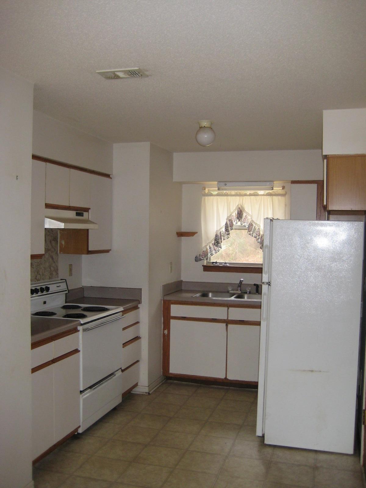 6003 Robin Road Crestview, FL 32539 - Photo 3 of 17 a kitchen with white cabinets and appliances
