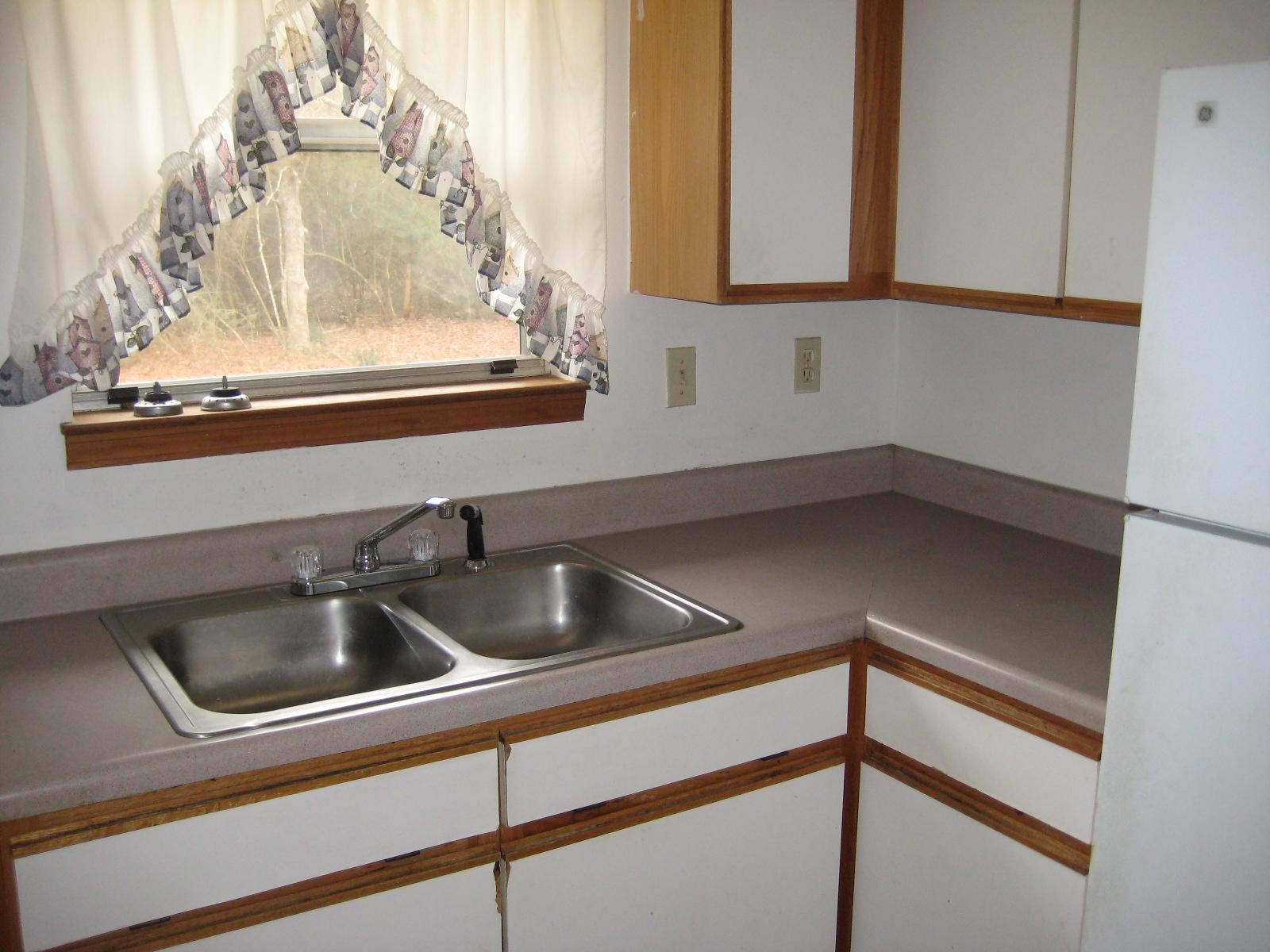 6003 Robin Road Crestview, FL 32539 - Photo 5 of 17 a kitchen with a sink and cabinets